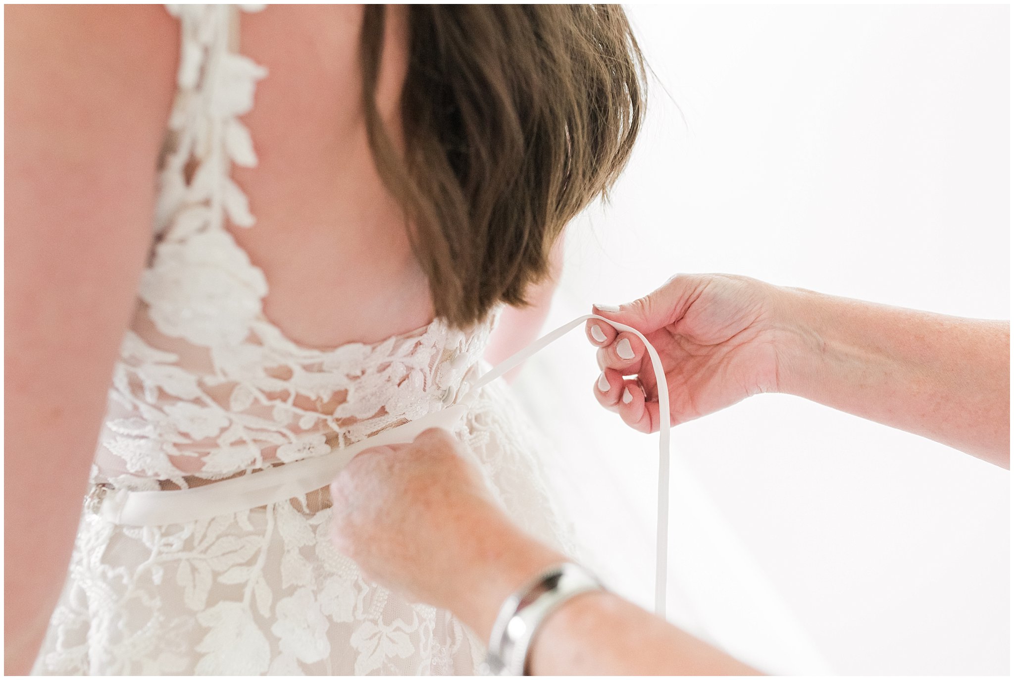 Mom tying back of bride's dress | Oak Hills Utah Dusty Rose and Gray Summer Wedding | Jessie and Dallin Photography