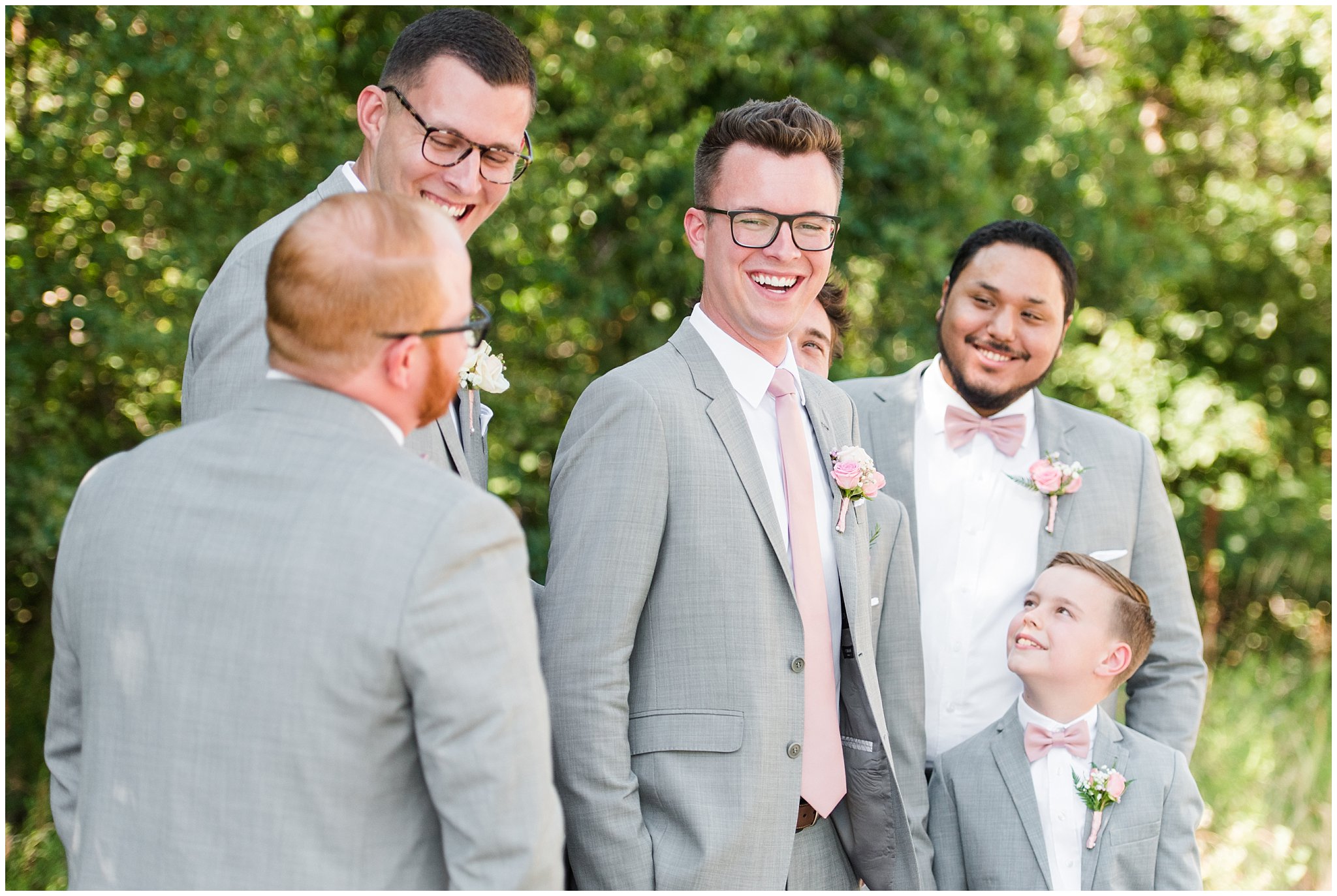 Groom and groomsmen laugh in gray suits with blush ties | Oak Hills Utah Dusty Rose and Gray Summer Wedding | Jessie and Dallin Photography