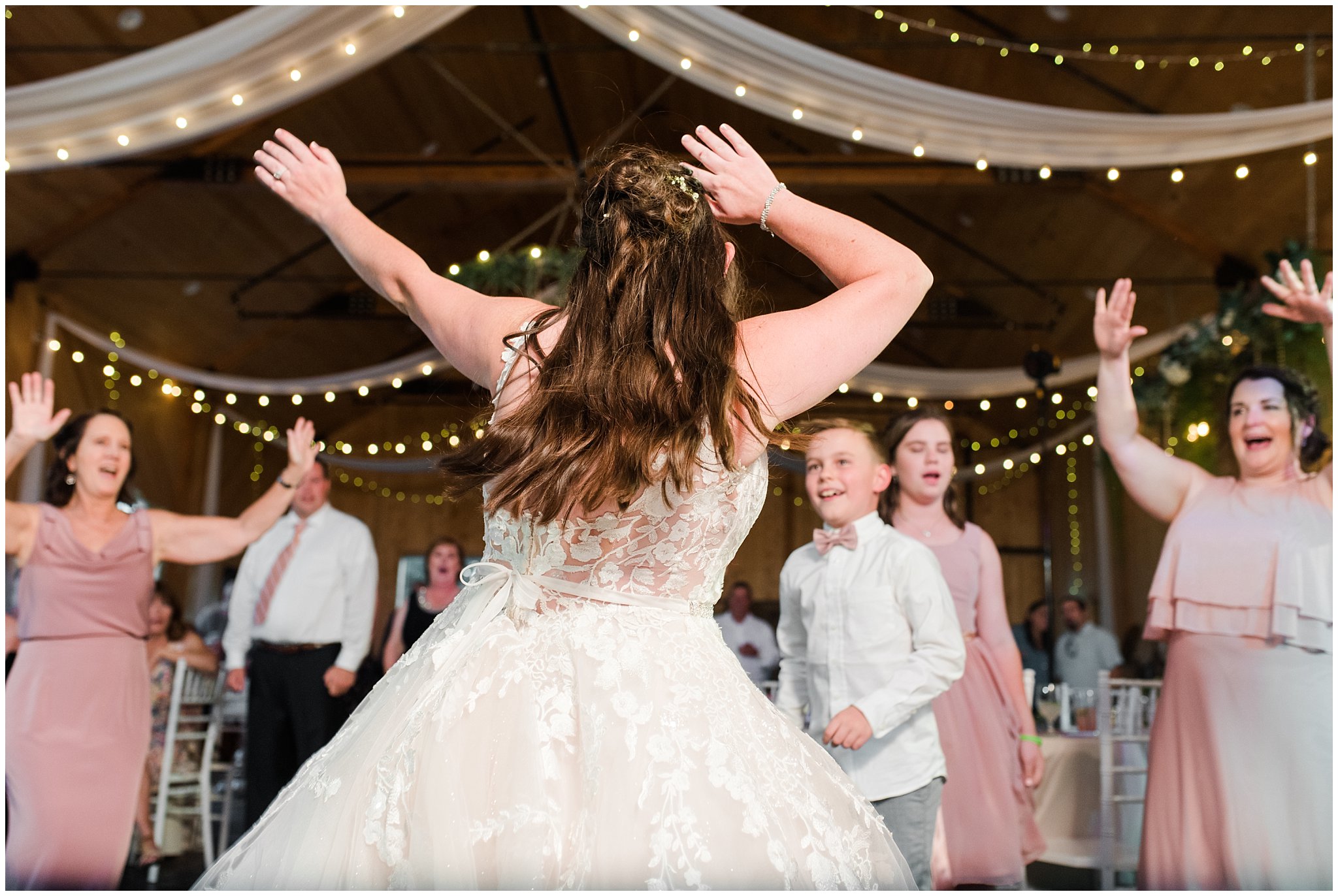 Bride busting a move during party dancing in barn | Oak Hills Utah Dusty Rose and Gray Summer Wedding | Jessie and Dallin Photography
