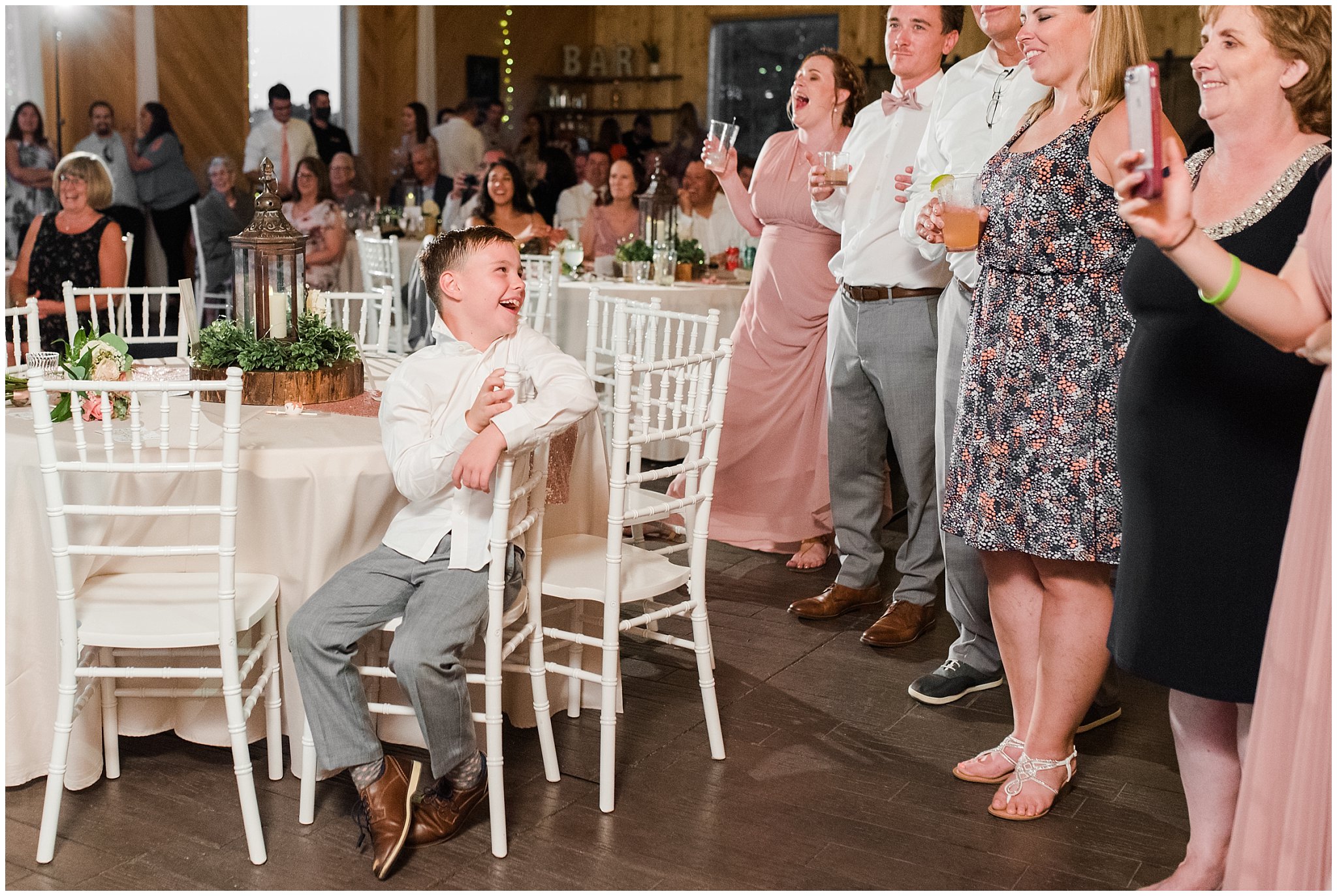 Shoe game reactions in barn | Oak Hills Utah Dusty Rose and Gray Summer Wedding | Jessie and Dallin Photography