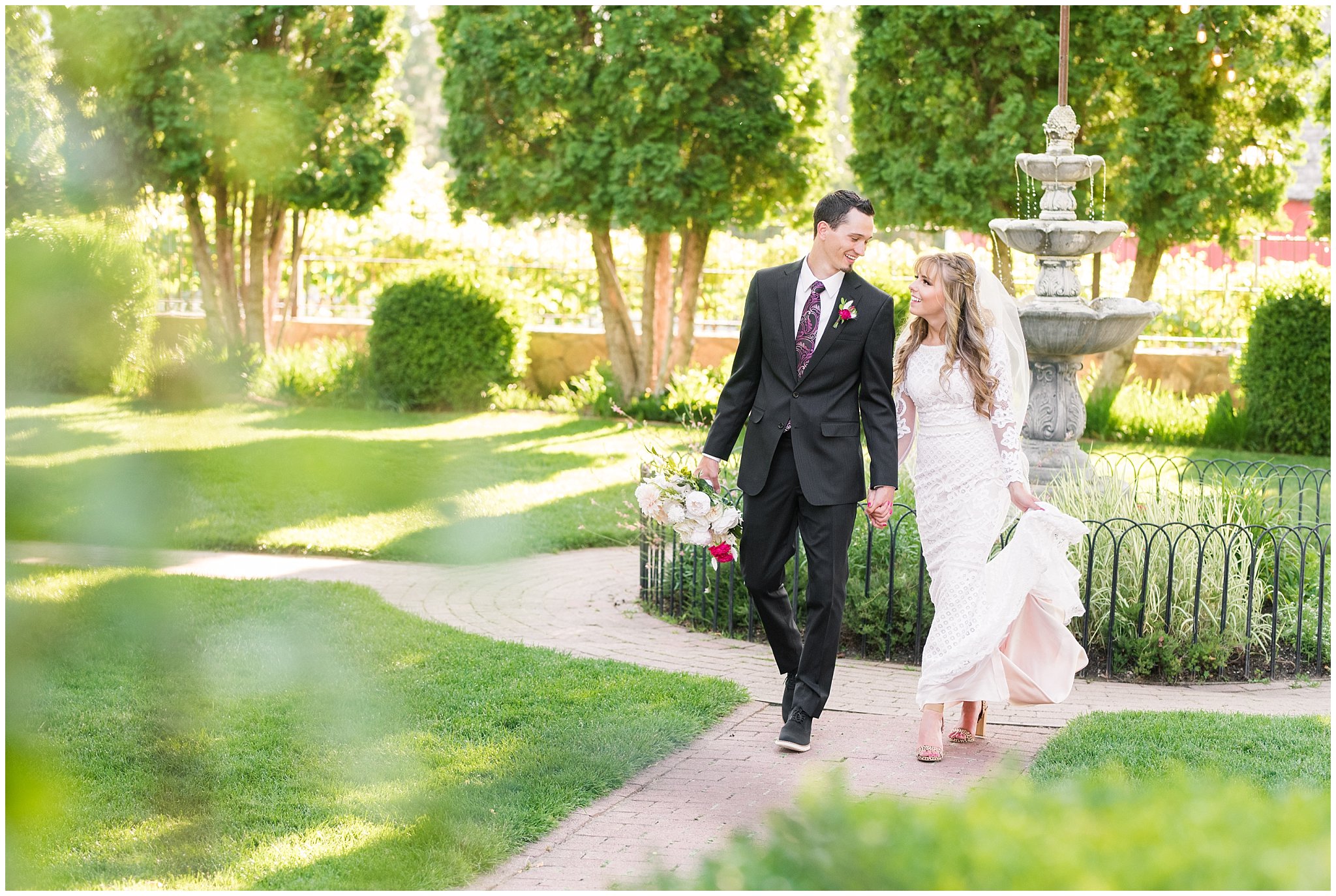 Bride and groom portraits candid moments laughing | white and deep pink florals with black suit and lace dress | Wadley Farms Summer Wedding | Jessie and Dallin Photography