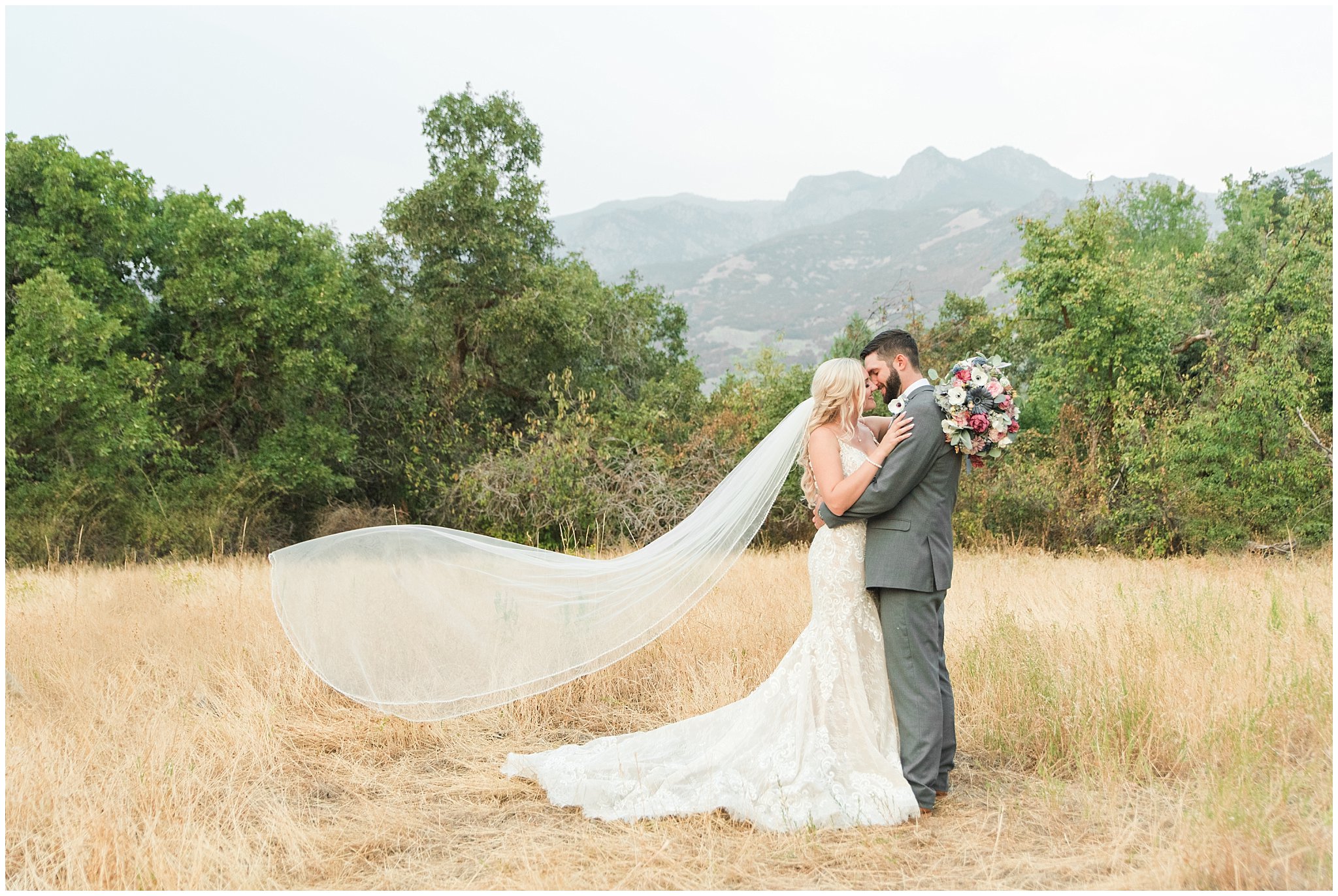 Bride and groom portraits with lace dress and cathedral veil and gray suit with blue floral tie | Dusty Blue and Rose Summer Wedding at Oak Hills Utah | Jessie and Dallin Photography