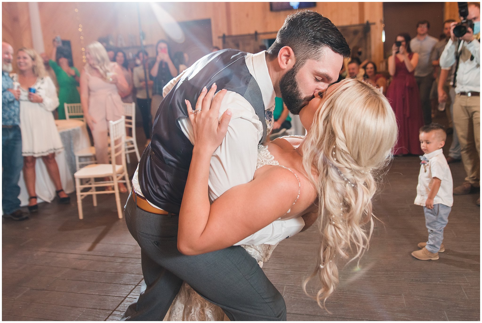 Bride and groom first dance in barn with lace dress and cathedral veil and gray suit with blue floral tie | Dusty Blue and Rose Summer Wedding at Oak Hills Utah | Jessie and Dallin Photography