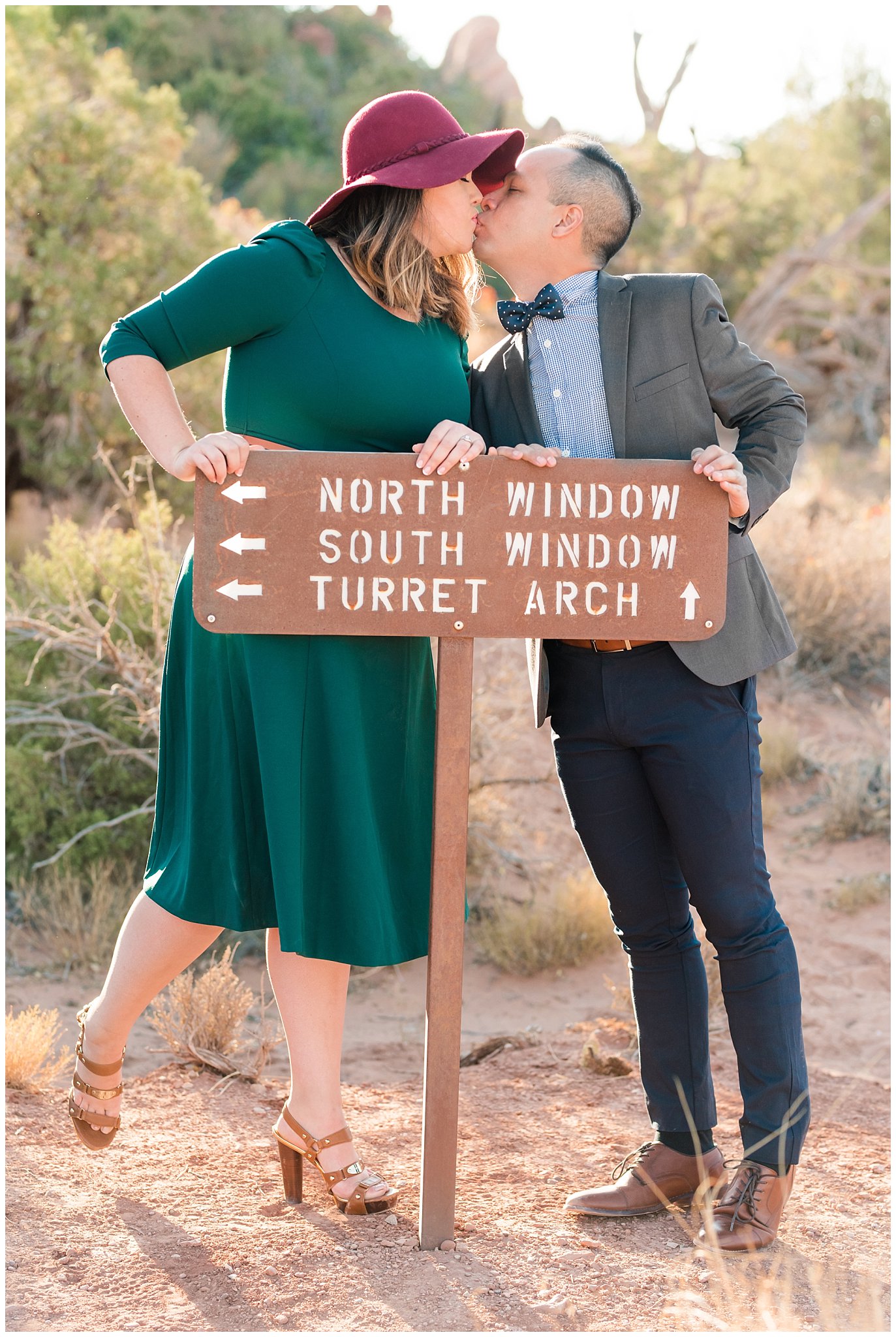 Couple dressed in green dress and grey and blue suit with bowtie for adventure engagement session at Arches National Park and Dead Horse Point Engagement | Jessie and Dallin Photography