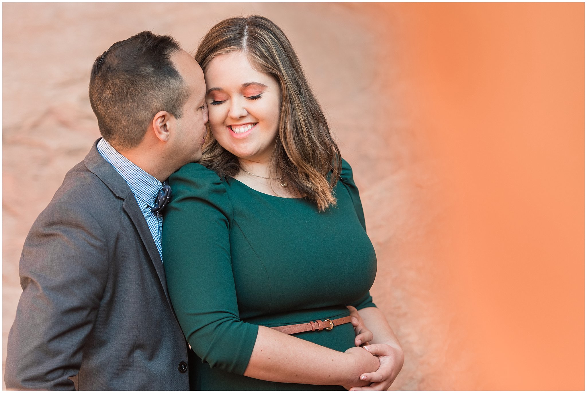 Couple dressed in green dress and grey and blue suit with bowtie for adventure engagement session at Arches National Park and Dead Horse Point Engagement | Jessie and Dallin Photography