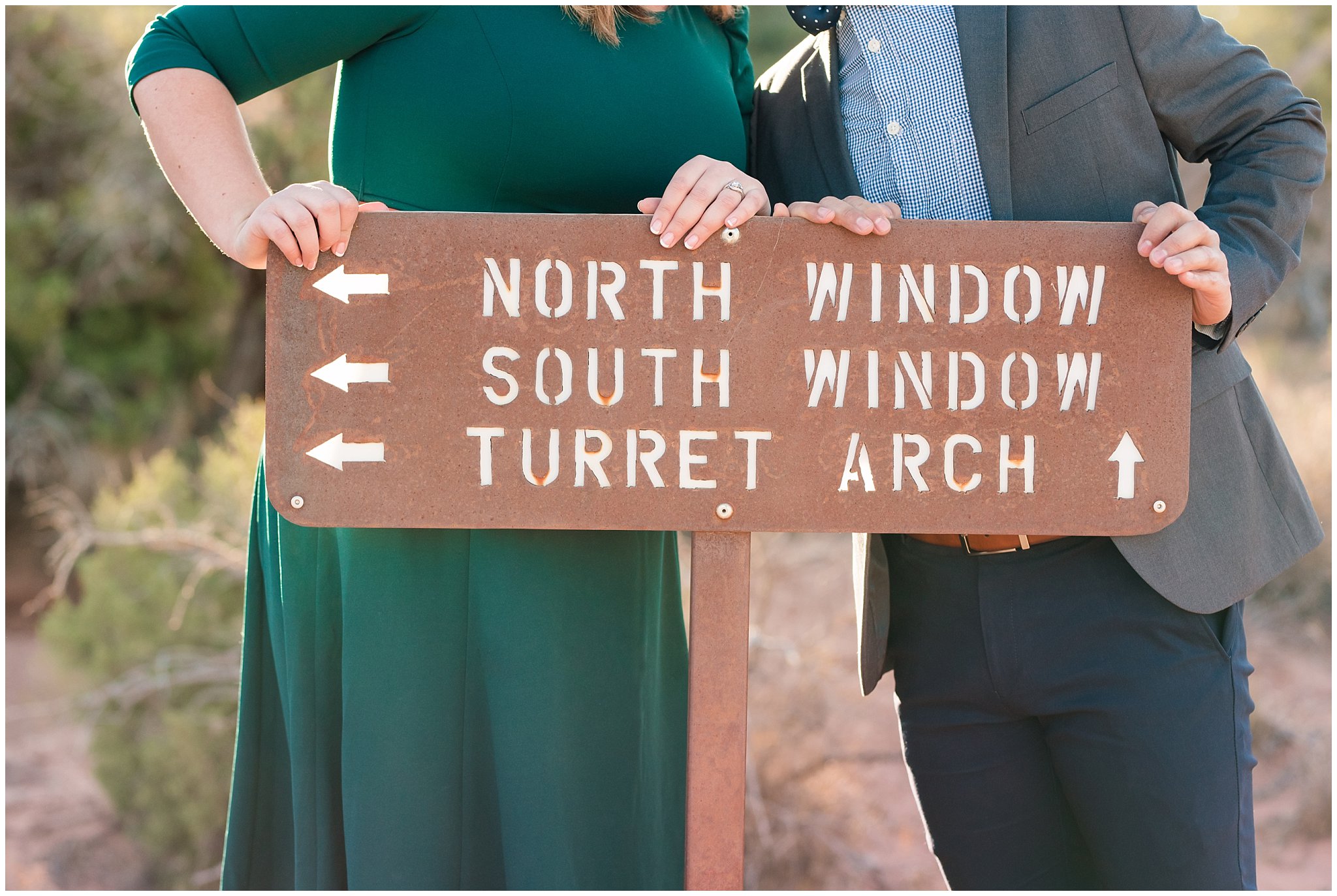 Couple dressed in green dress and grey and blue suit with bowtie for adventure engagement session at Arches National Park and Dead Horse Point Engagement | Jessie and Dallin Photography