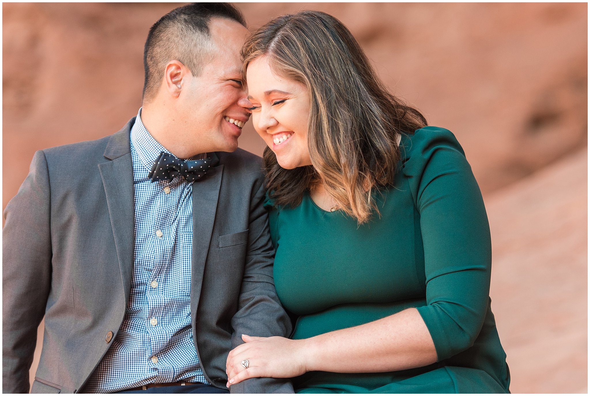 Couple dressed in green dress and grey and blue suit with bowtie for adventure engagement session at Arches National Park and Dead Horse Point Engagement | Jessie and Dallin Photography