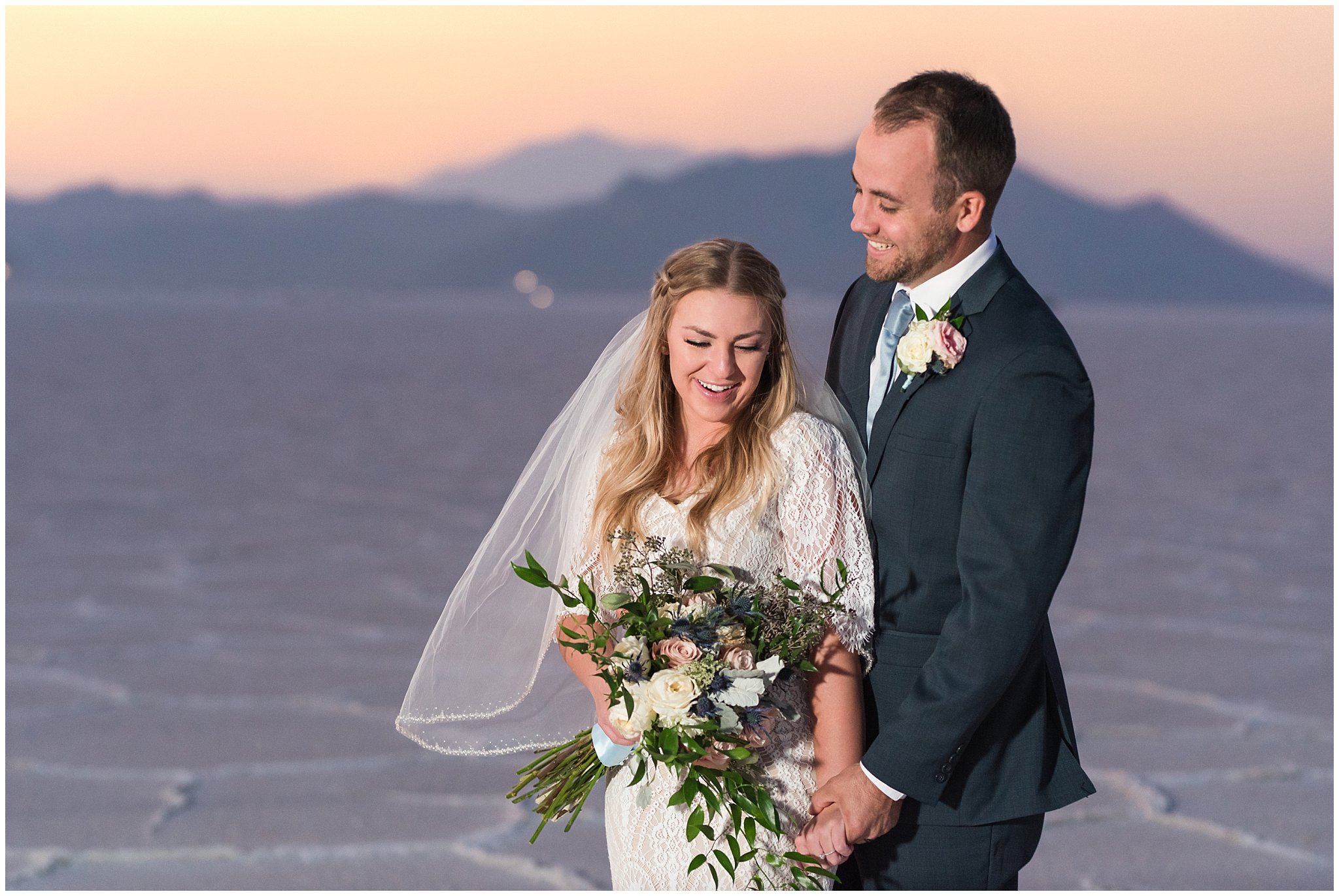 Bride and Groom at sunset in lace detail dress and blue suit for Adventure Session | Bonneville Salt Flats Sunset Wedding Formal Session | Jessie and Dallin Photography