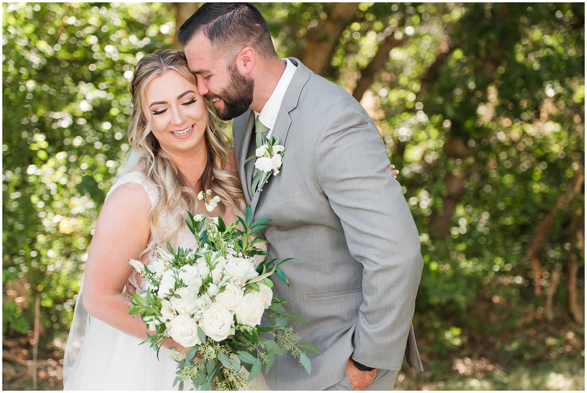 Bride and groom first look in woods wearing gray suit and sage green tie and champagne dress with veil | Sage Green and Gray Summer Wedding at Oak Hills | Jessie and Dallin Photography