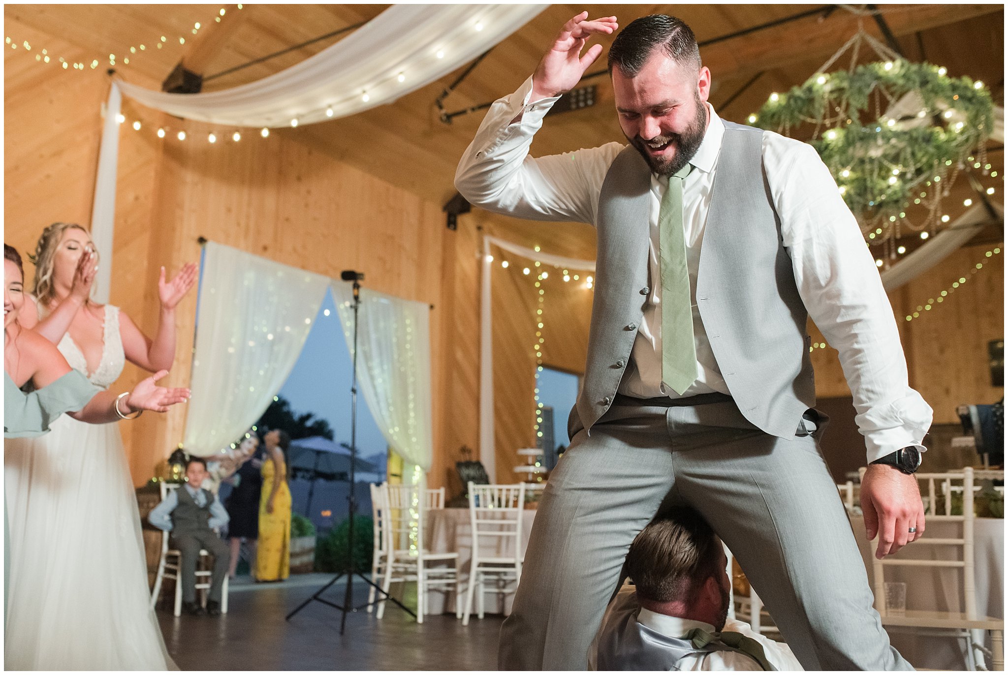 Party dancing in a barn during wedding reception | Sage Green and Gray Summer Wedding at Oak Hills | Jessie and Dallin Photography