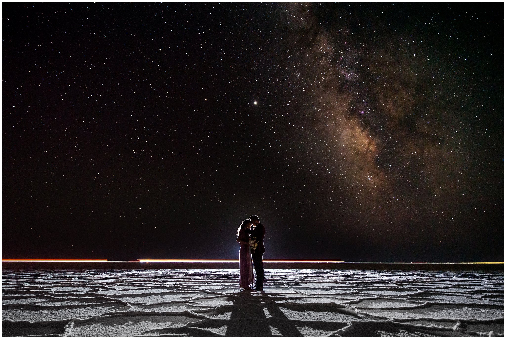 Astrophotography with couple wearing a dusty rose dress and burgundy suit with white and pink bouquet at the Bonneville Salt Flats Milky Way Anniversary Session | Jessie and Dallin Photography