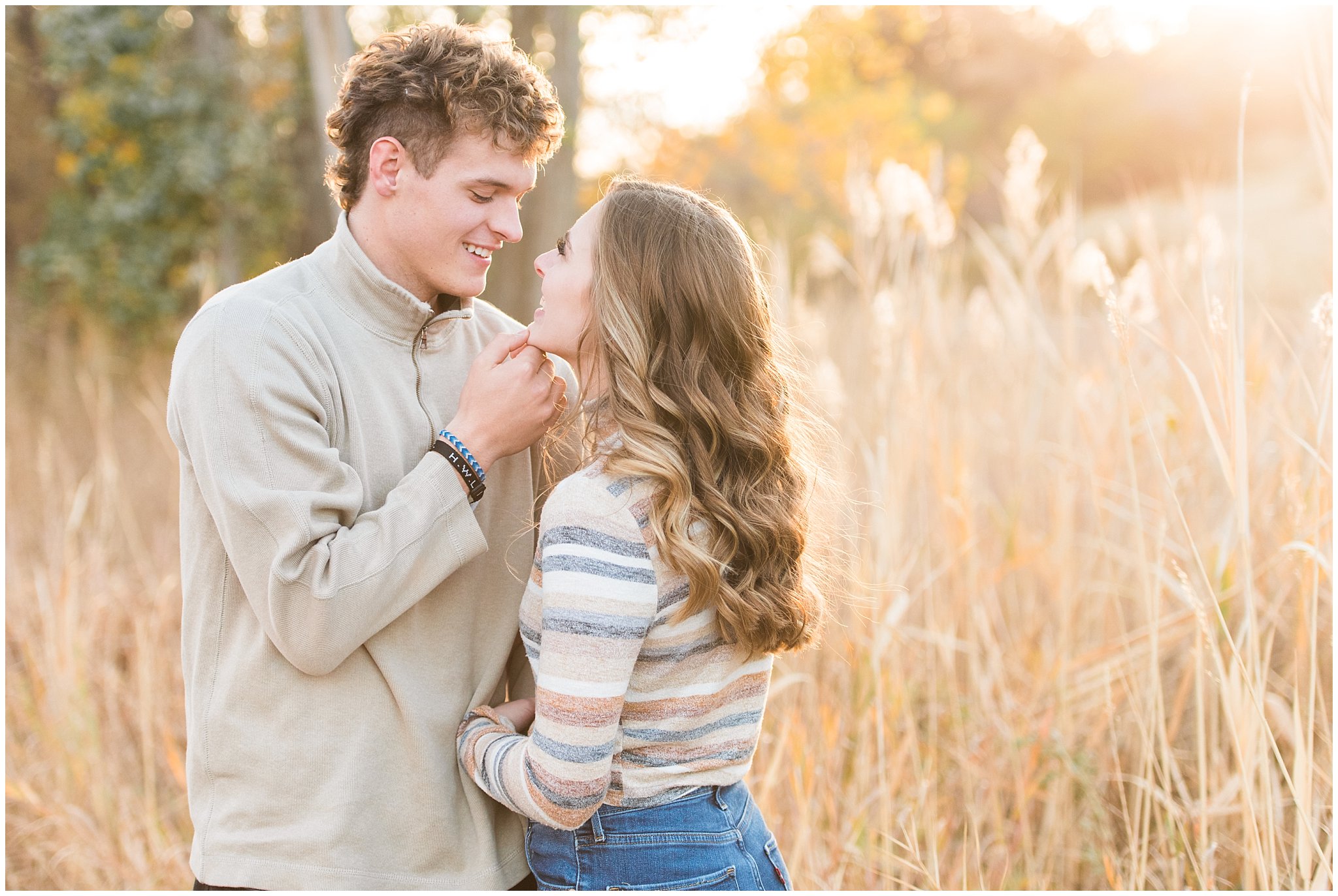 Candid photos of couple in casual cream colored fall sweaters | Utah Fall Engagement Session in a Golden Field | Jessie and Dallin Photography