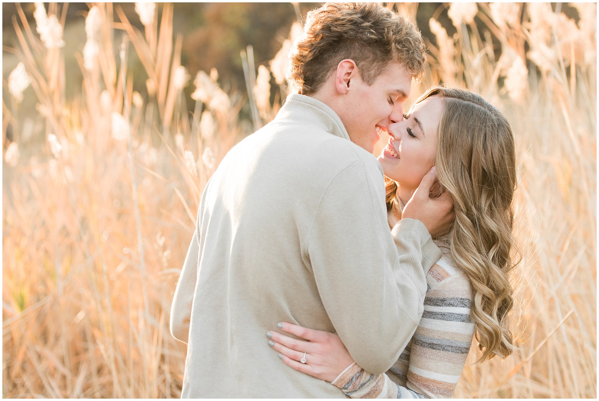 Candid photos of couple in casual cream colored fall sweaters | Utah Fall Engagement Session in a Golden Field | Jessie and Dallin Photography