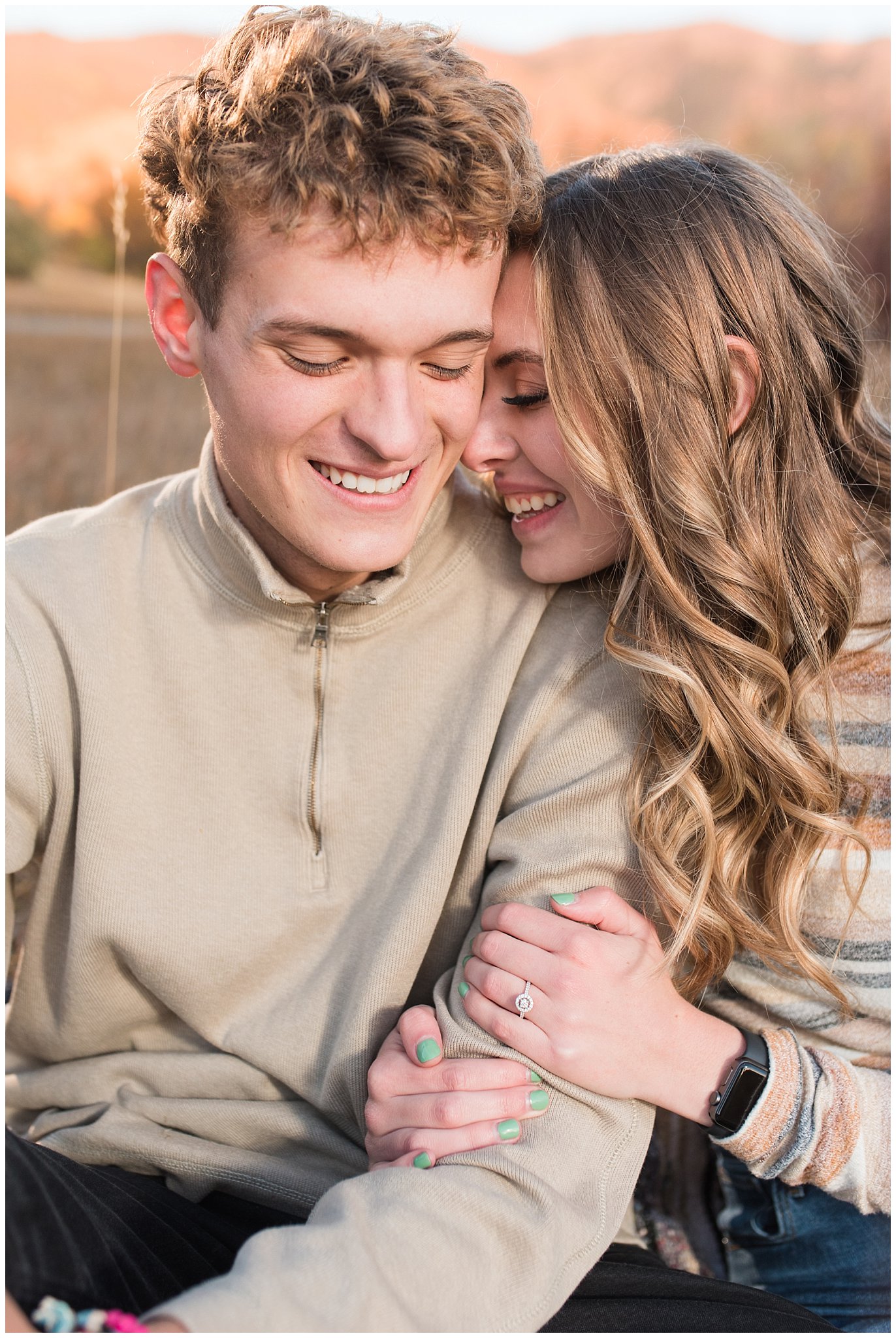 Candid photos of couple in casual cream colored fall sweaters | Utah Fall Engagement Session in a Golden Field | Jessie and Dallin Photography