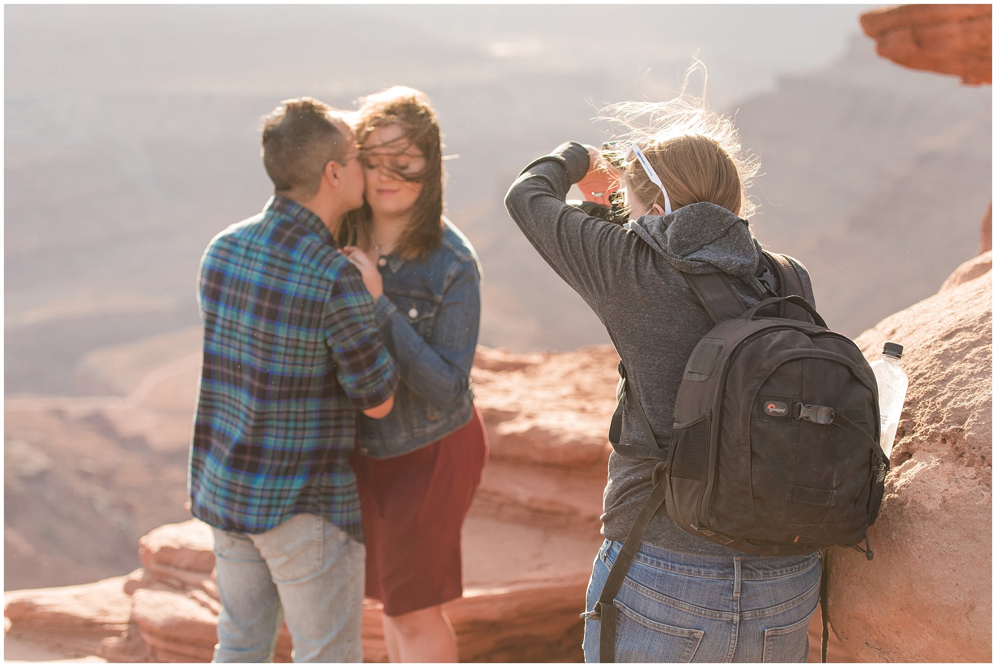 Jessie photographing couple in a wind storm at Dead Horse Point