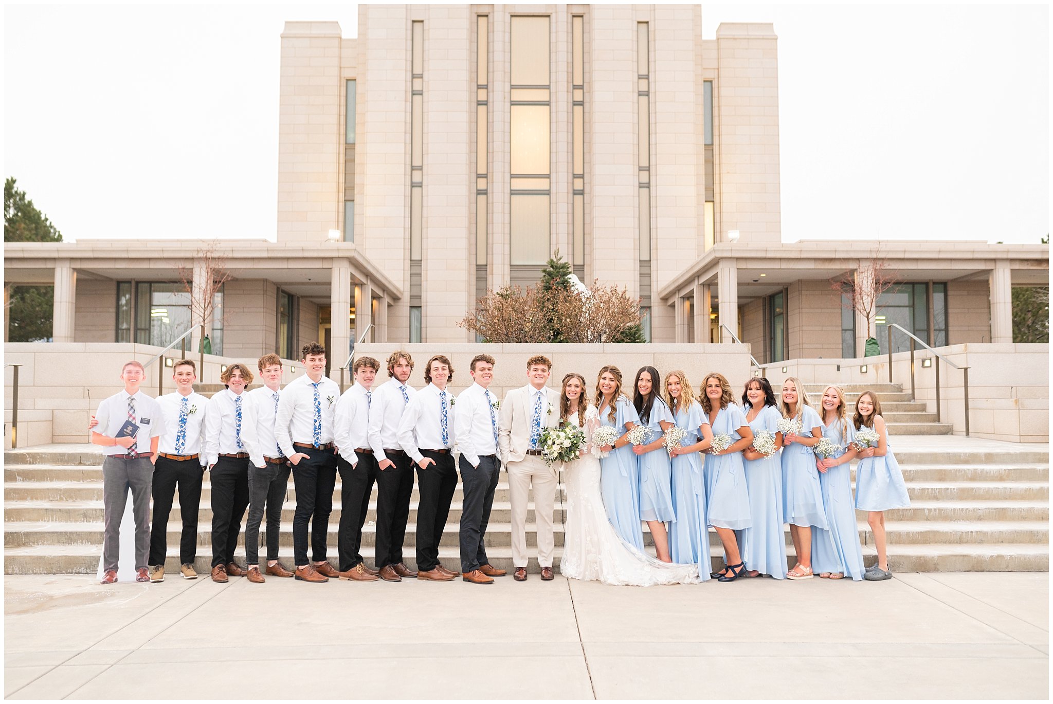 Wedding party with light blue dresses and ties with white bouquets | Oquirrh Mountain Temple and Draper Day Barn Winter Wedding | Jessie and Dallin Photography