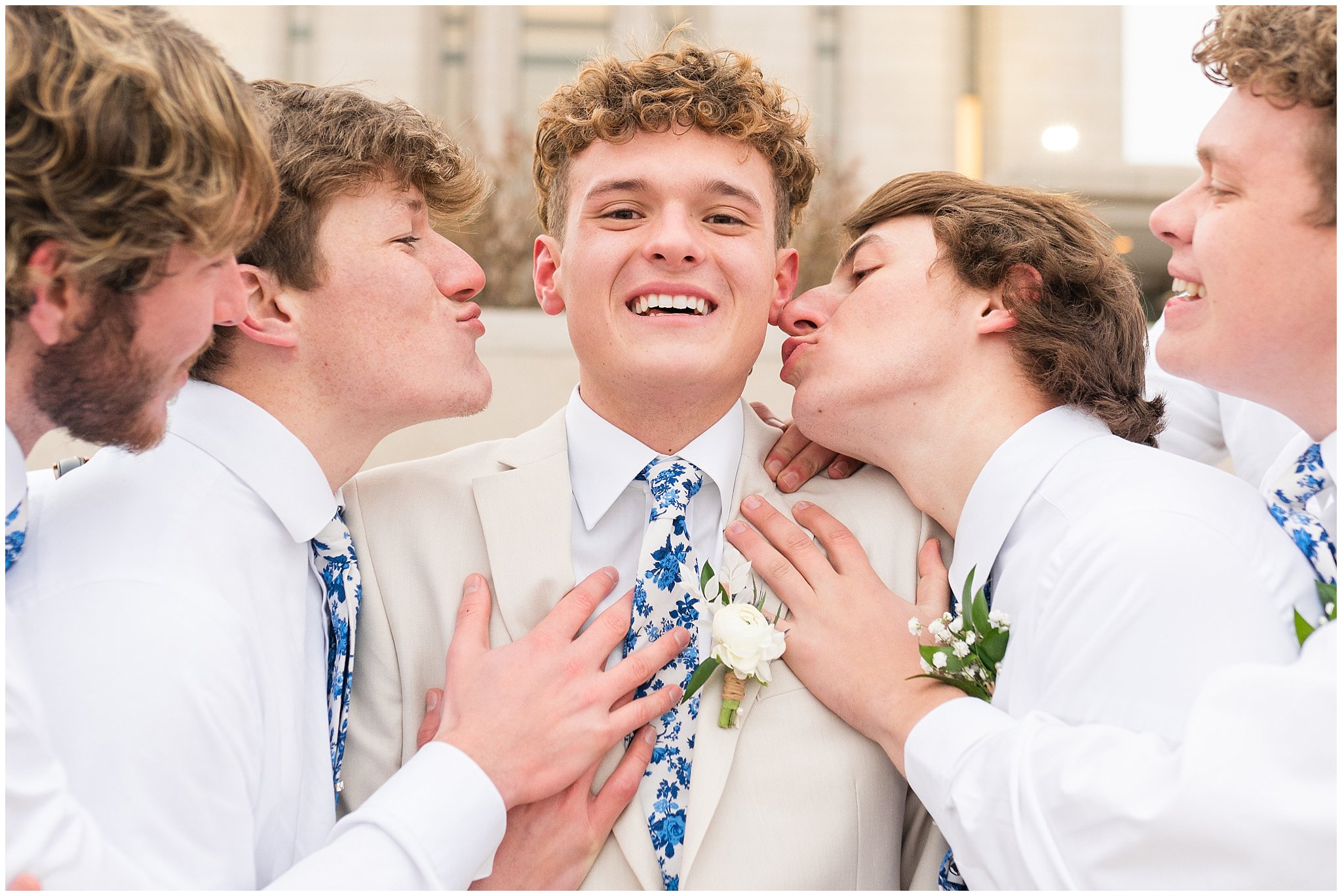 Groom surrounded by groomsmen candid moment | Oquirrh Mountain Temple and Draper Day Barn Winter Wedding | Jessie and Dallin Photography