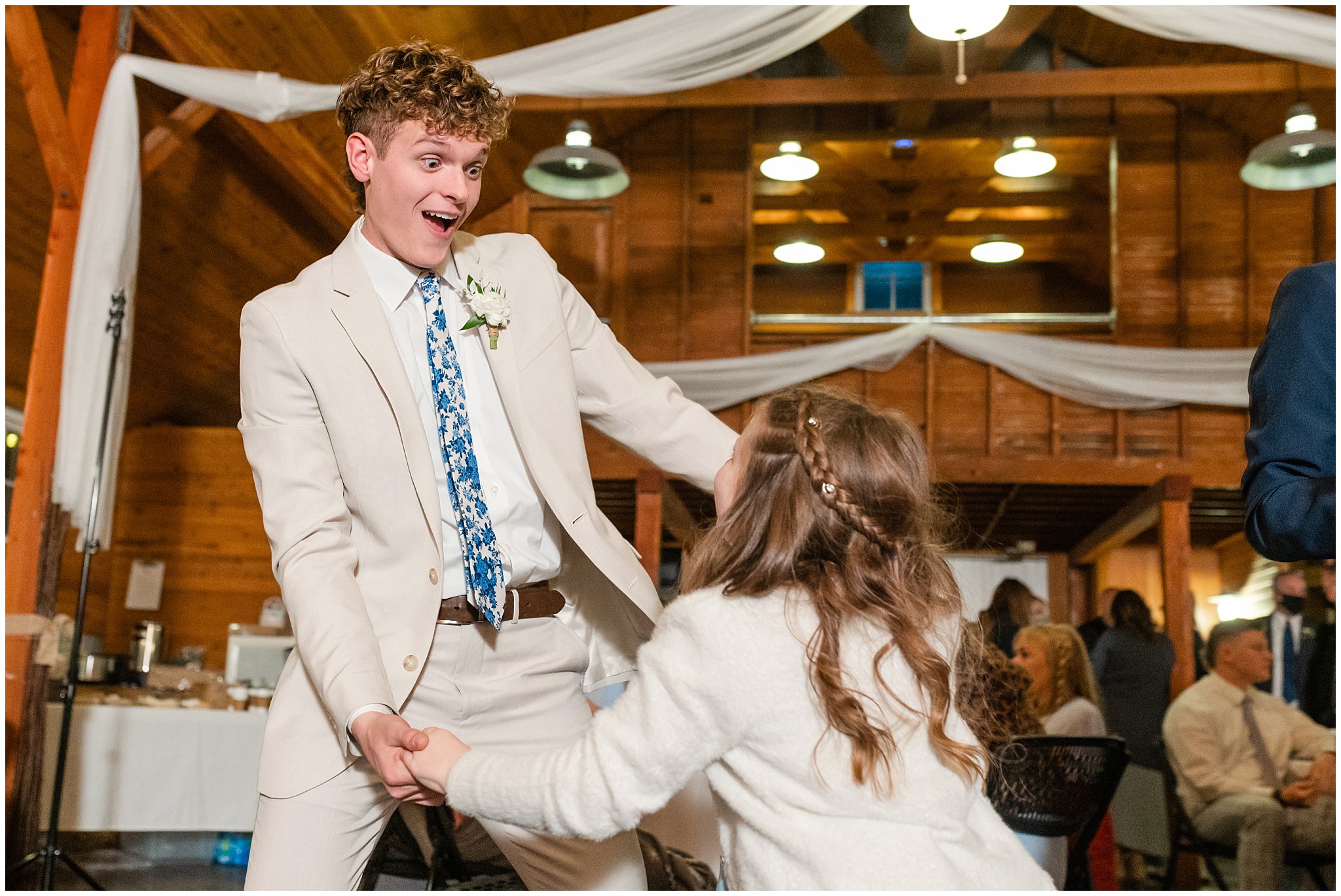 Group party dancing and laughing during barn wedding | Oquirrh Mountain Temple and Draper Day Barn Winter Wedding | Jessie and Dallin Photography