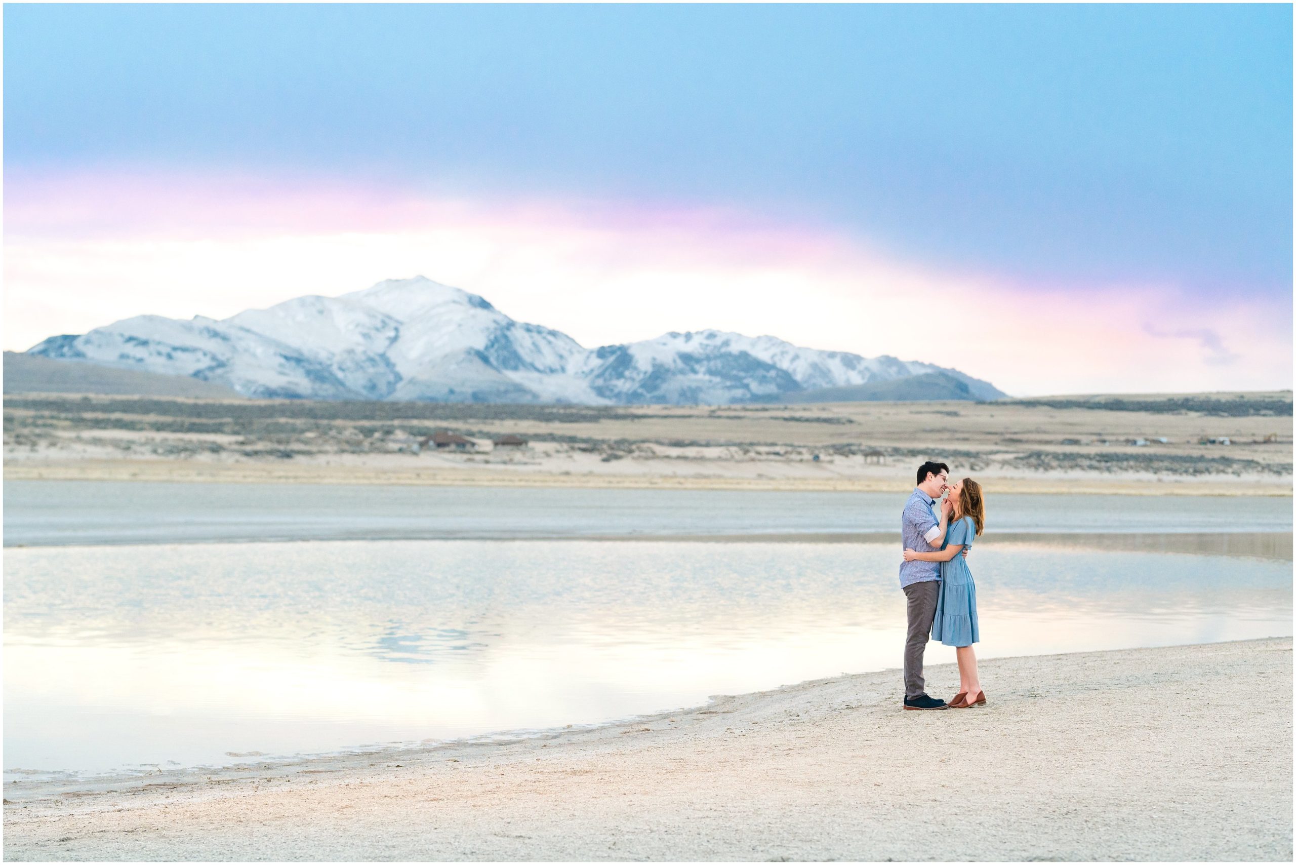 Couple dressed in different blues and greys at sunset during Antelope Island Stormy Engagement Session | Jessie and Dallin Photography