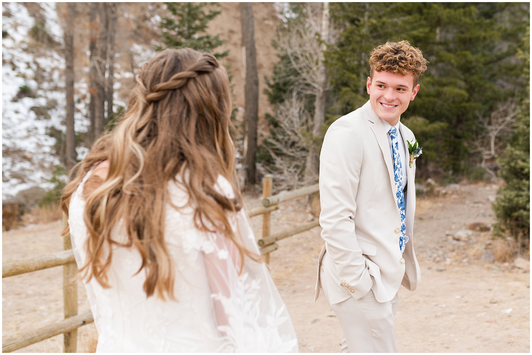 Bride and groom in the mountains during their first look wearing lace dress with veil and white floral bouquet and creme colored suit with blue tie | Tibble Fork Winter Formal Session | Jessie and Dallin Photography