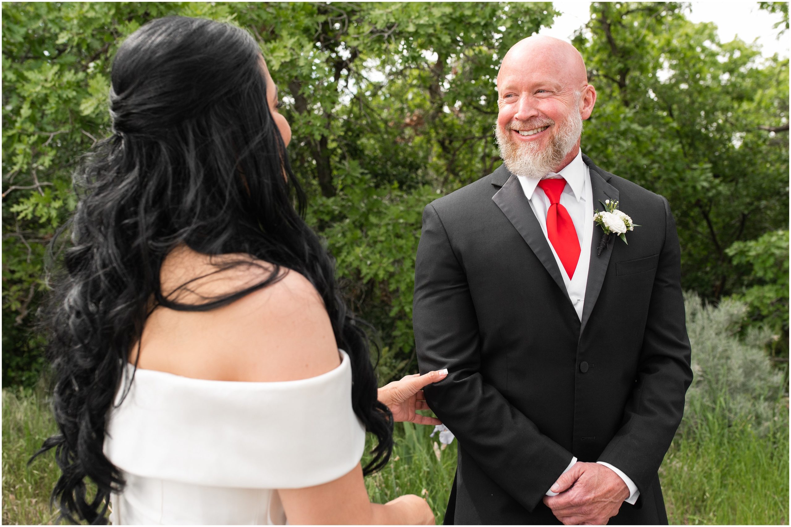 Bride and groom share first look in woods | Red and Black Oak Hills Utah Spring Wedding | Jessie and Dallin Photography