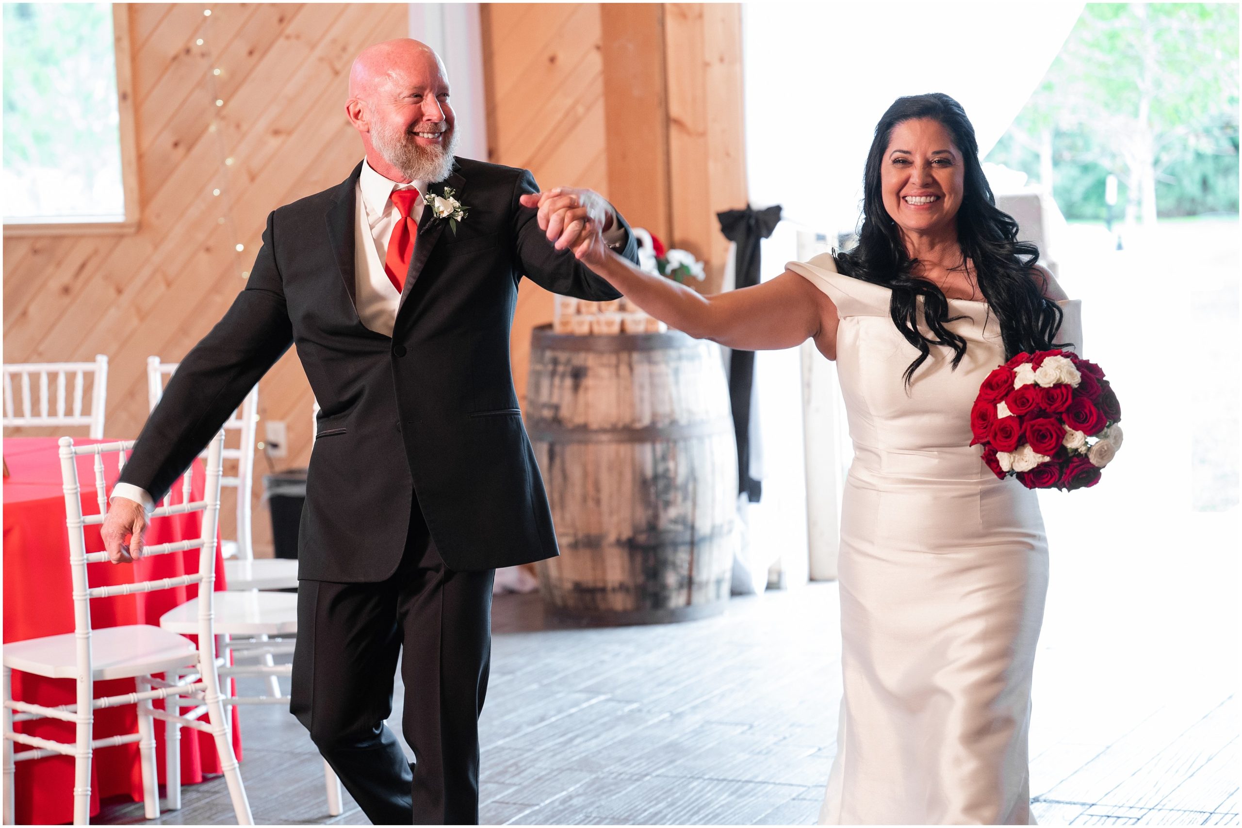 Bride and groom grand entrance and first dance in rustic barn | Red and Black Oak Hills Utah Spring Wedding | Jessie and Dallin Photography