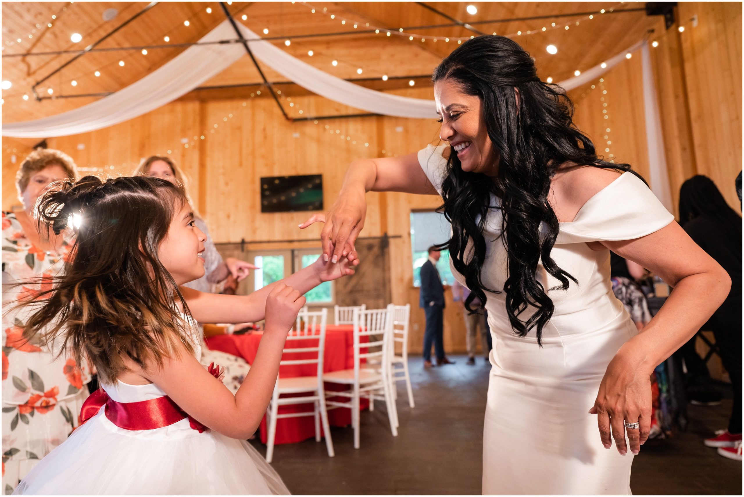 Group and party dancing in rustic barn | Red and Black Oak Hills Utah Spring Wedding | Jessie and Dallin Photography