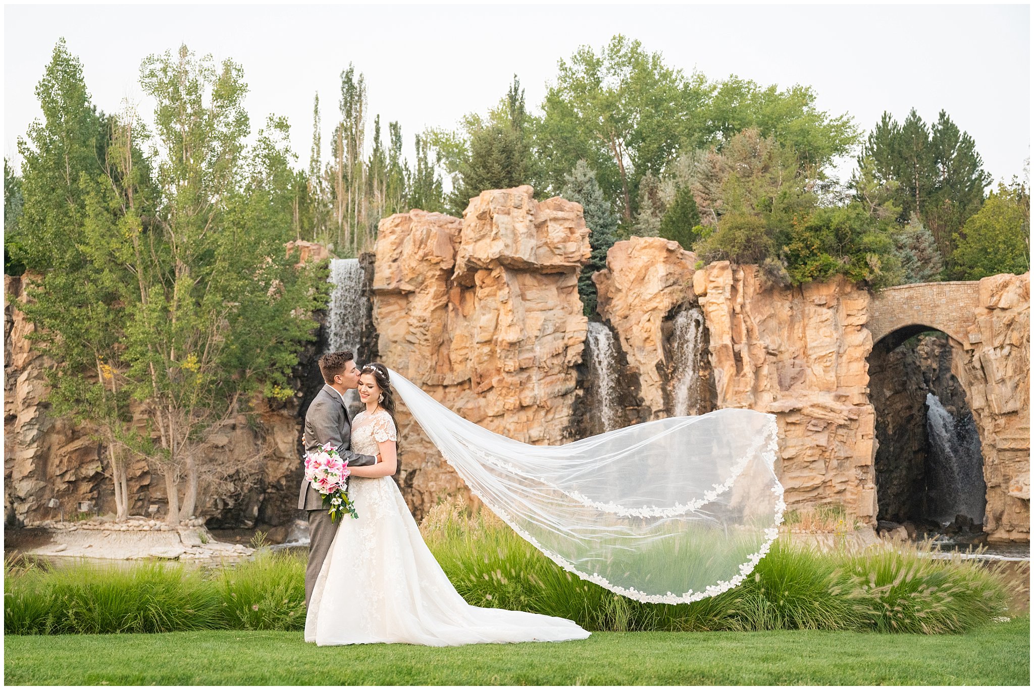 Bride and Groom in front of waterfalls during wedding portraits during the summer surrounded by flowers and gardens | Thanksgiving Point Ashton Garden Formal Session | Jessie and Dallin Photography