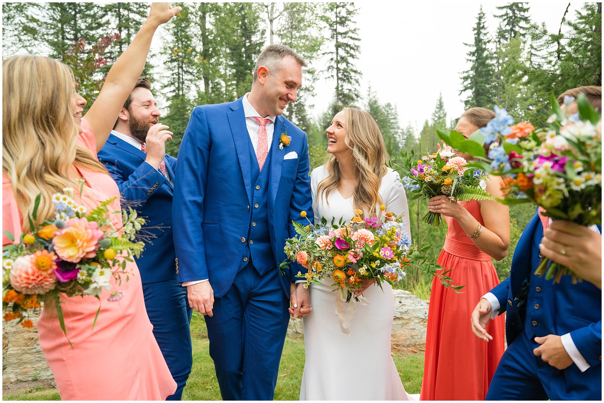 Wedding party portraits with bridesmaids in coral dresses with wildflowers, and groomsmen in blue suits with coral ties | Mountainside Weddings Kalispell Montana Destination Wedding | Jessie and Dallin Photography