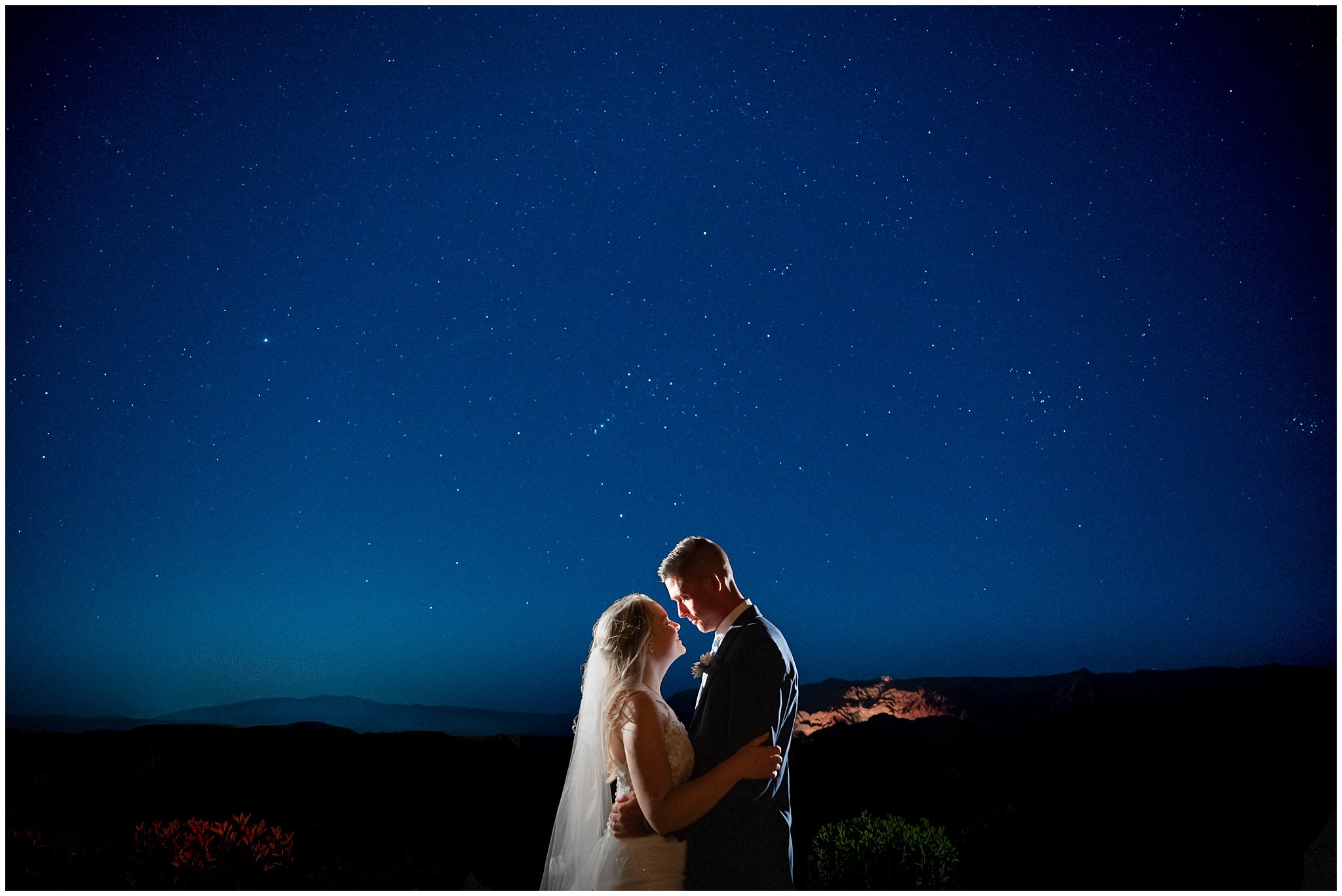 Wedding in the red rocks of southern Utah. Couple outside with the night sky.