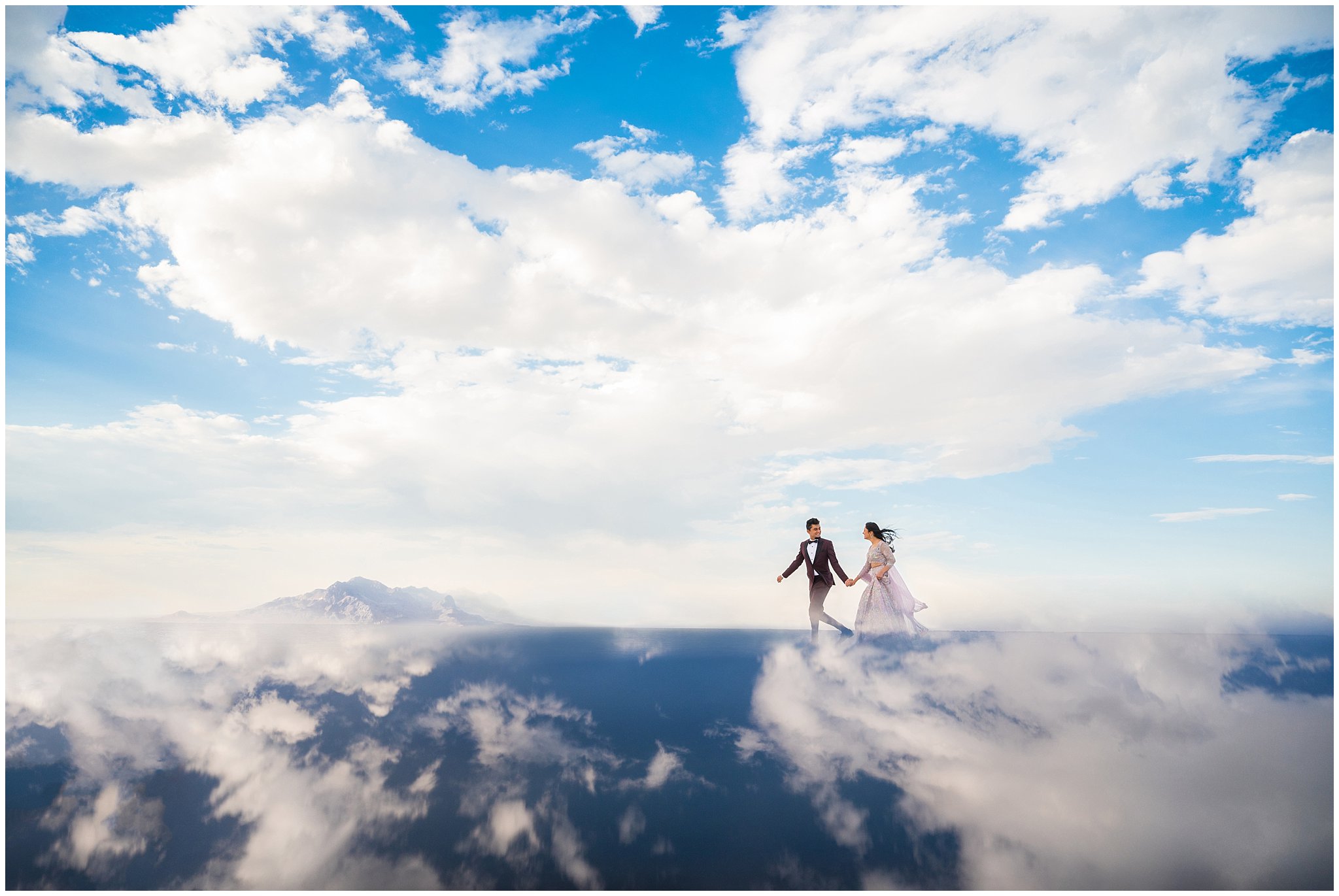 Couple running in the clouds | Indian wedding session at the Bonneville Salt Flats