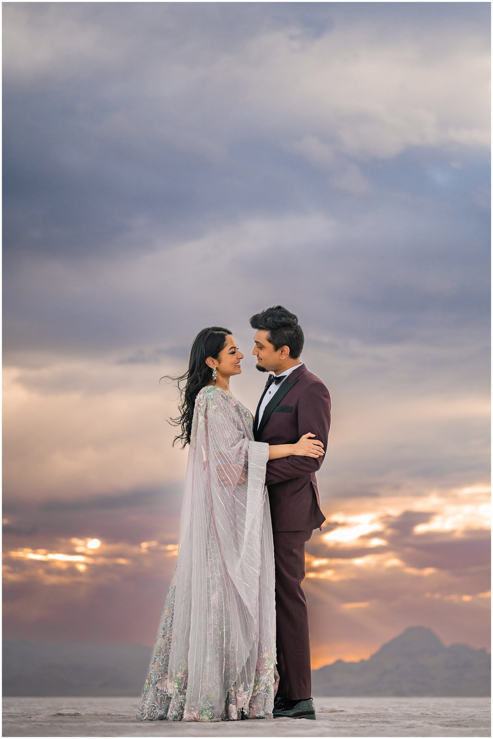 Couple together at sunset during their Indian wedding session at the Bonneville Salt Flats