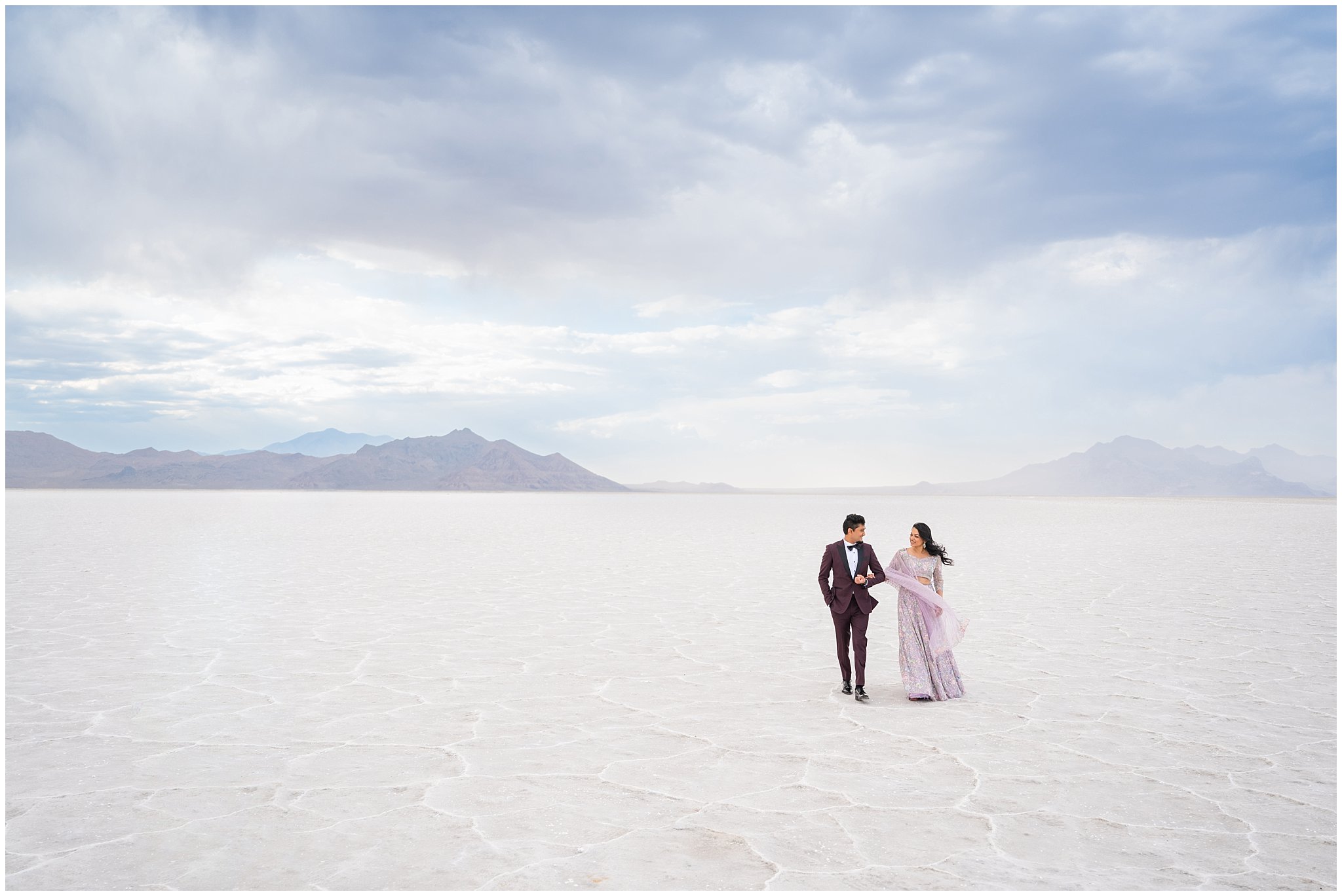 Couple walking together during their Indian wedding session at the Bonneville Salt Flats