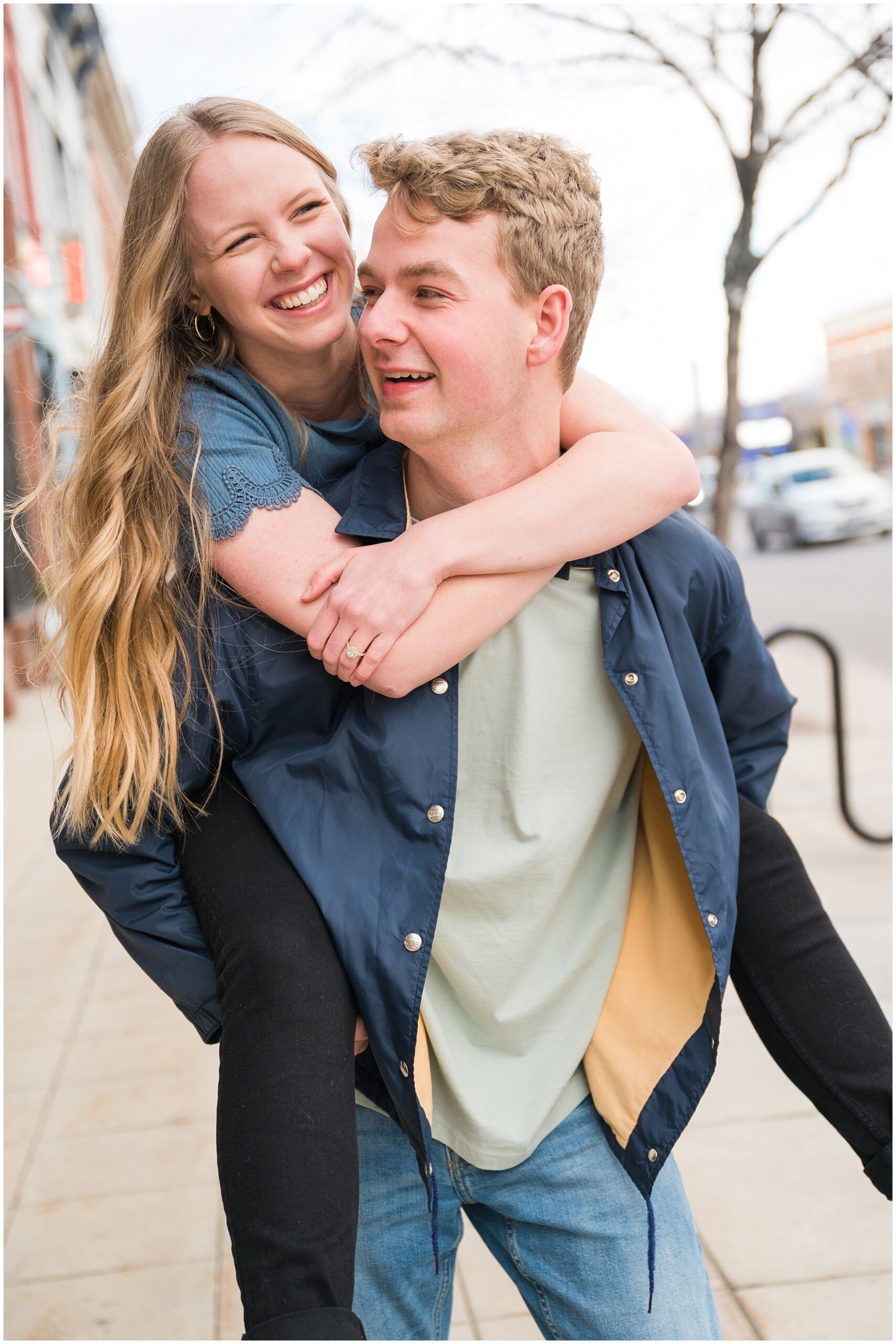 Couple taking fun and candid engagement photos on Main Street in Logan, Utah | Cache Valley and Utah State University Engagement Session | Jessie and Dallin Photography