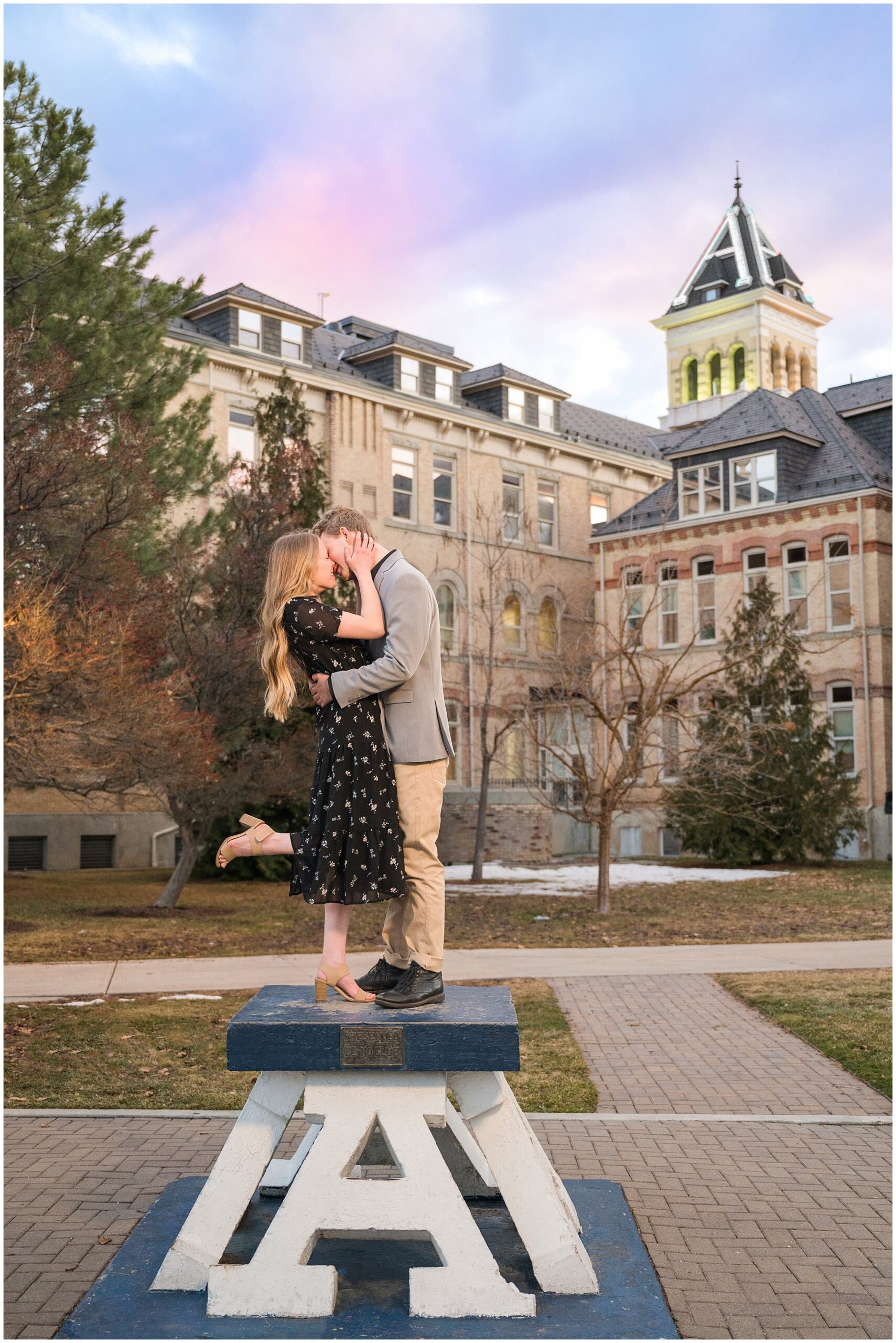 Couple standing on the Block A at sunset at Utah State University for their engagement photos in Logan, Utah | Cache Valley and Utah State University Engagement Session | Jessie and Dallin Photography
