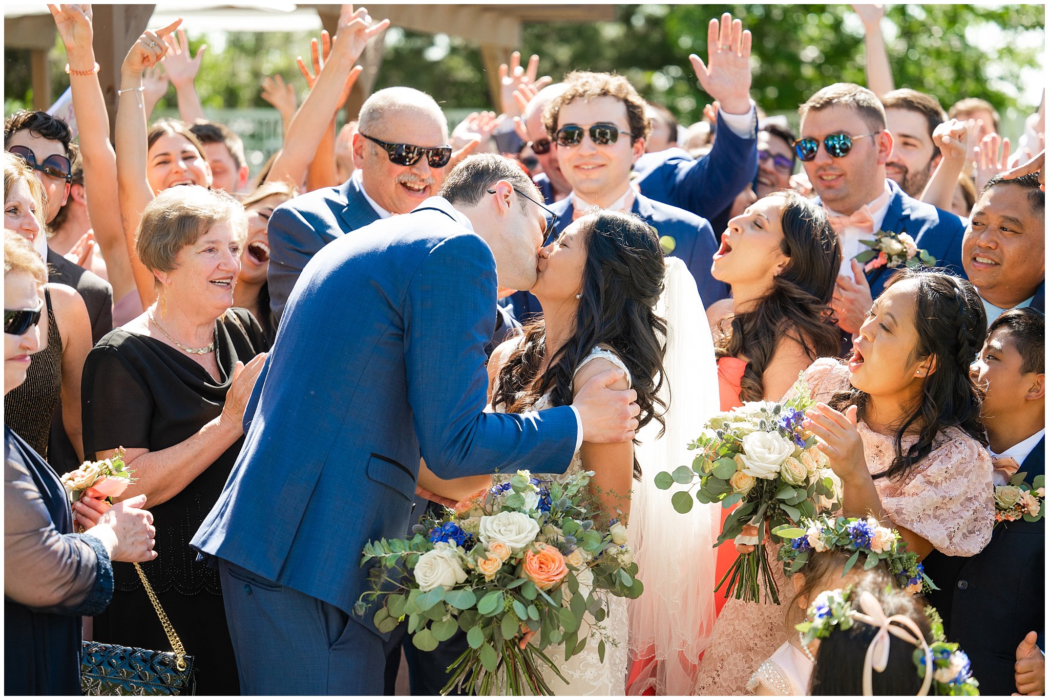 Bride and groom kiss while surrounded by family and friends after ceremony at Oak Hills in Utah | Oak Hills Utah Destination Wedding | Jessie and Dallin Photography