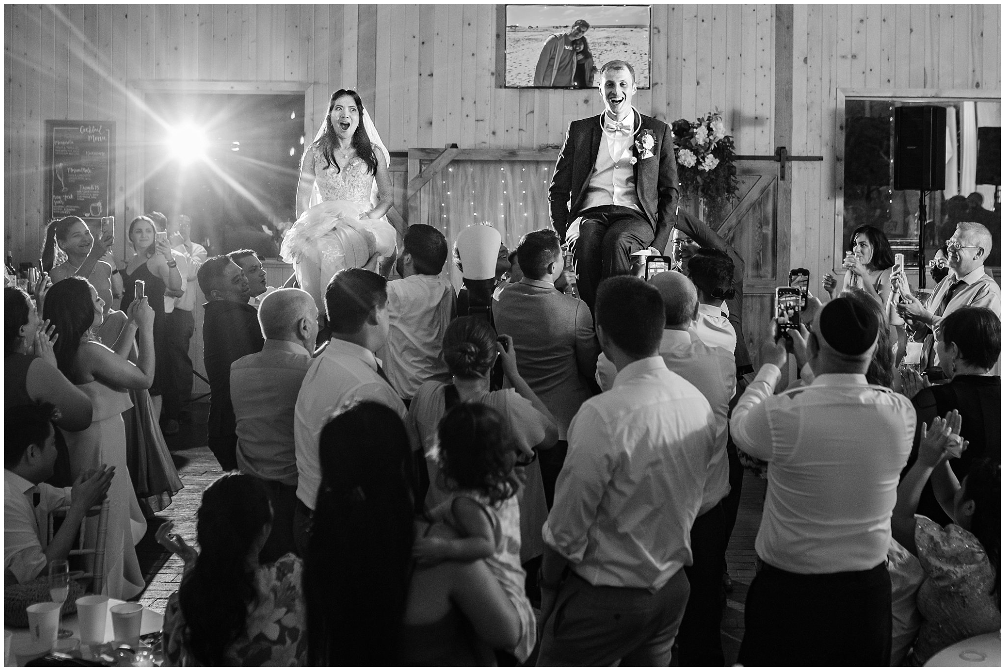 Bride and groom lifted in hora dance during reception in a barn | Oak Hills Utah Destination Wedding | Jessie and Dallin Photography