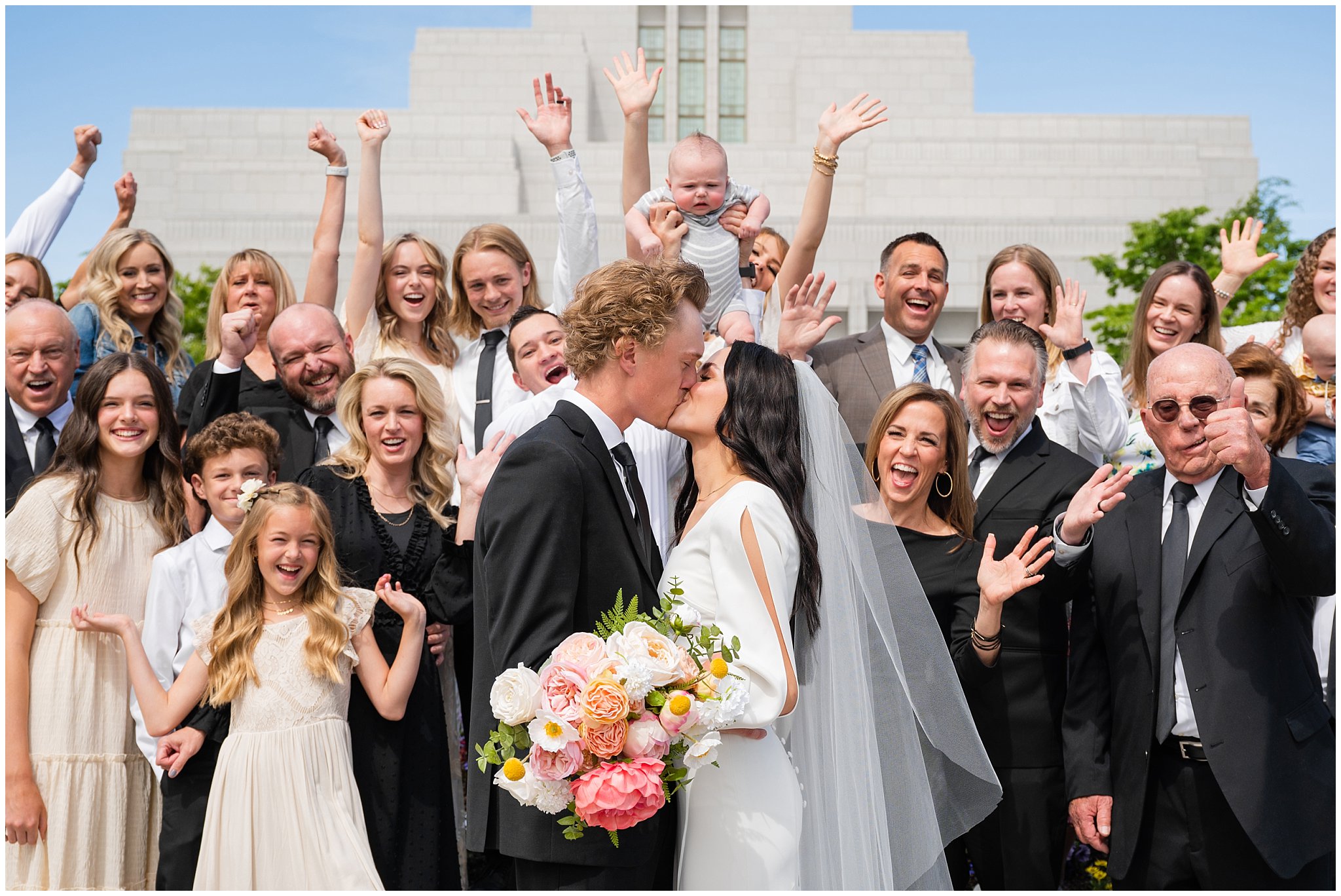 Large family photo cheering in front of the temple | Draper Temple and Wadley Farms Summer Castle Wedding | Jessie and Dallin Photography