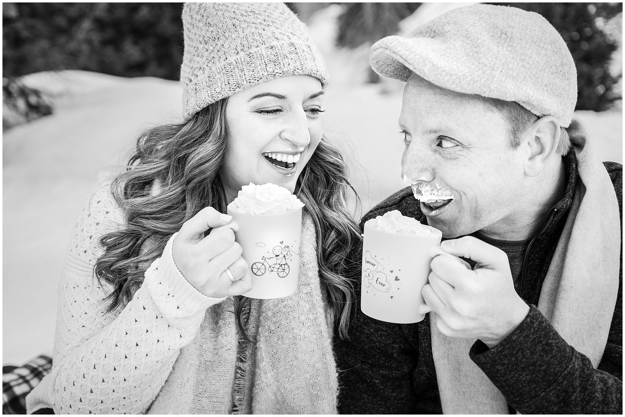 Couple in cute winter outfits having a hot chocolate picnic in the Utah mountains in the snow | Big Cottonwood Canyon Winter Engagement Session | Jessie and Dallin Photography
