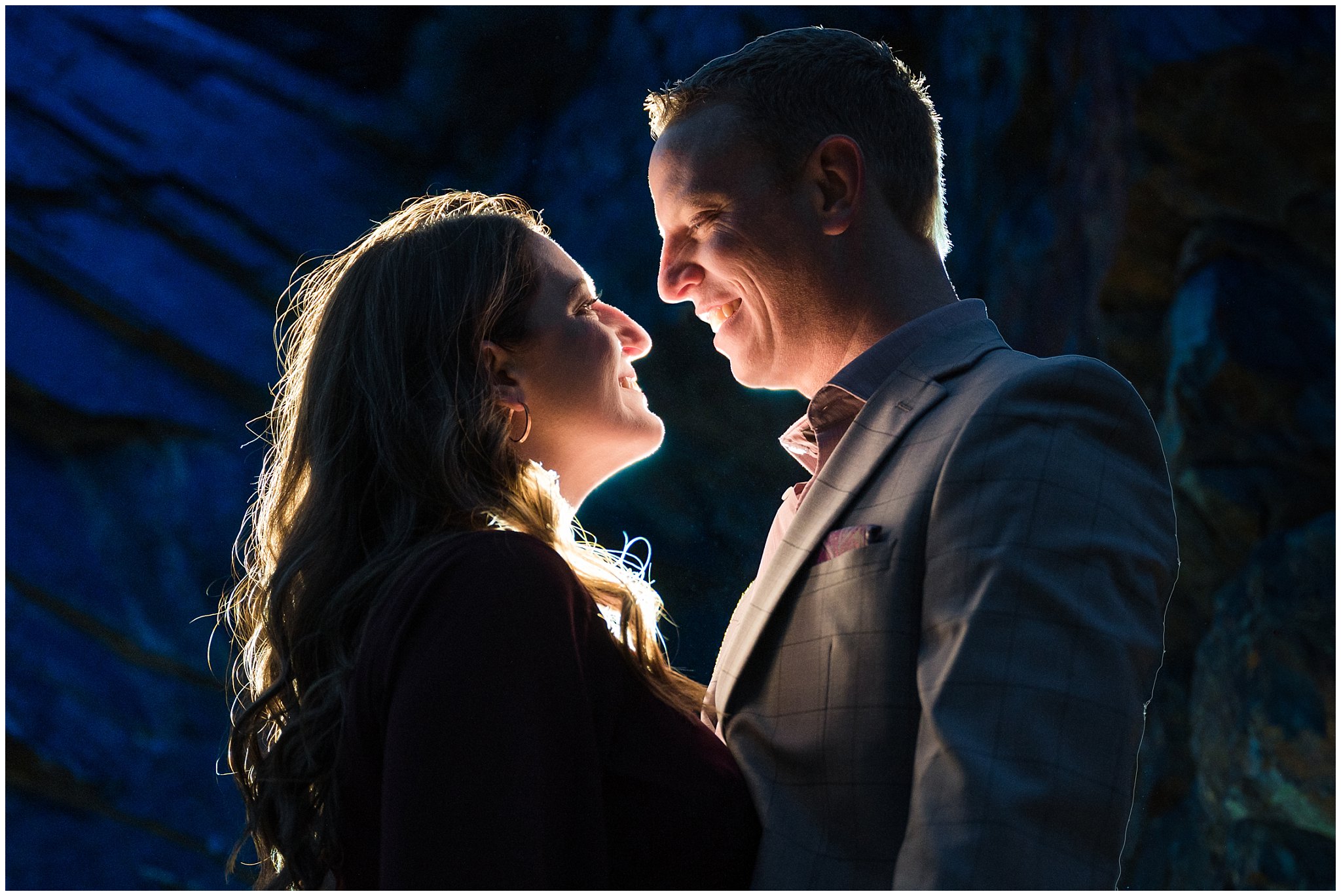 Couple dressed up in formal outfits sharing moments in the Utah mountains in the snow with off camera flash | Big Cottonwood Canyon Winter Engagement Session | Jessie and Dallin Photography