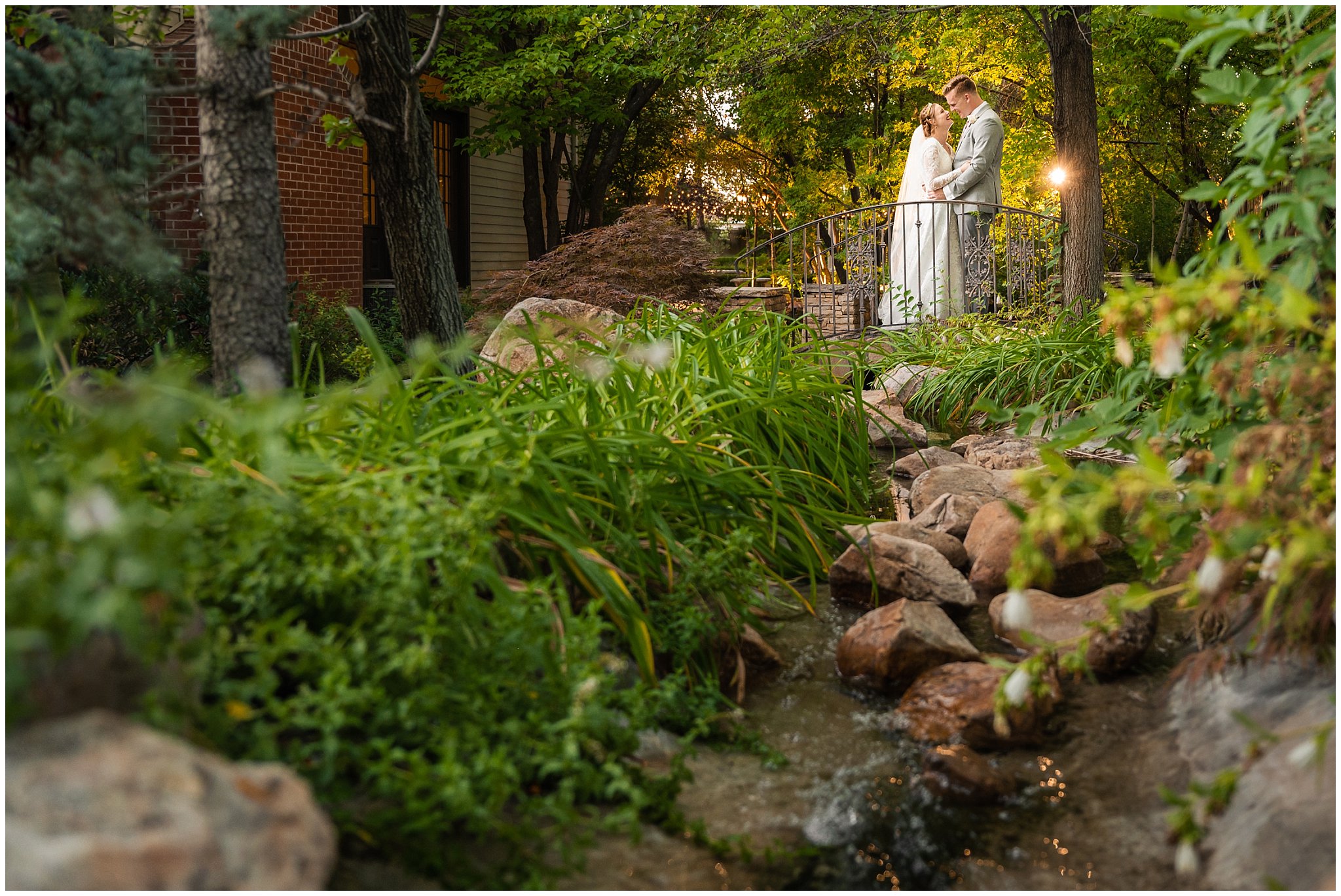 Bride and groom surrounded by the green trees and stream at Eldredge Manor | Bountiful Temple and Eldredge Manor Wedding | Jessie and Dallin Photography