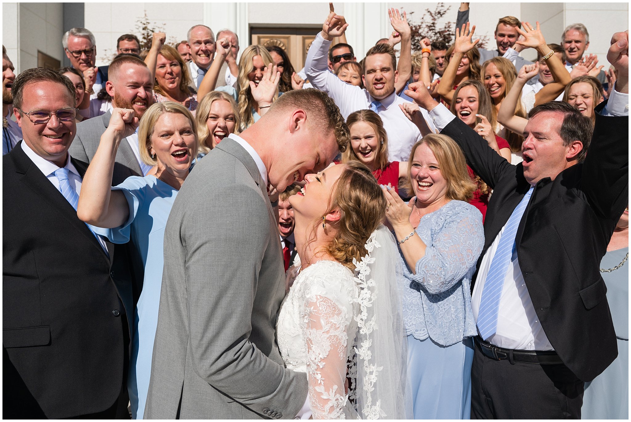 Bride and groom kiss surrounded by friends and family at the Bountiful Temple | Bountiful Temple and Eldredge Manor Wedding | Jessie and Dallin Photography