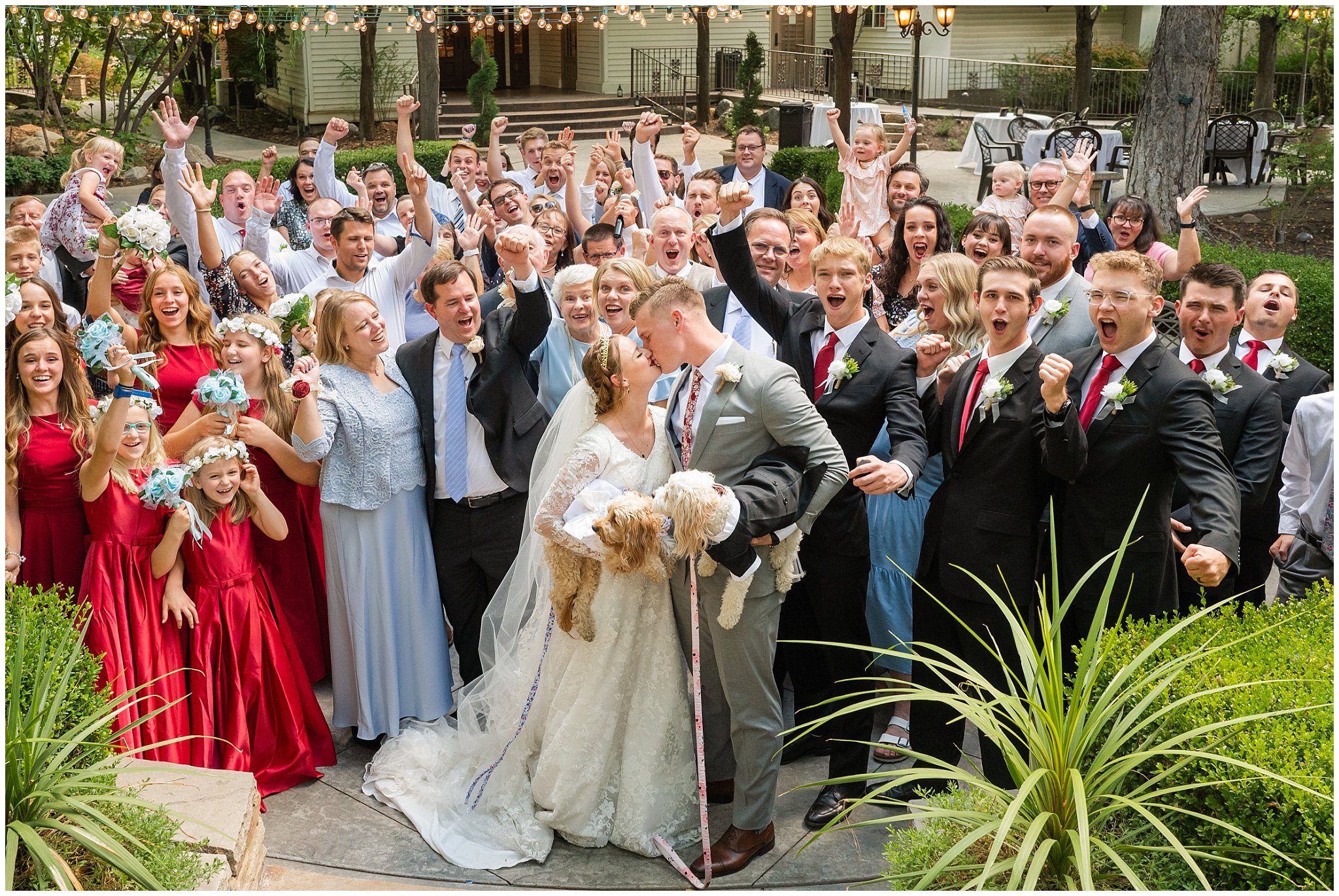 Bride and groom kiss surrounded by the cheers of their guests at Eldredge Manor | Bountiful Temple and Eldredge Manor Wedding | Jessie and Dallin Photography
