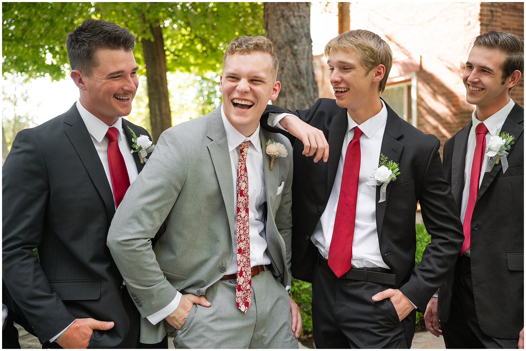 Black and red wedding party portraits as the groom is tossed in the air outside at Eldredge Manor | Bountiful Temple and Eldredge Manor Wedding | Jessie and Dallin Photography