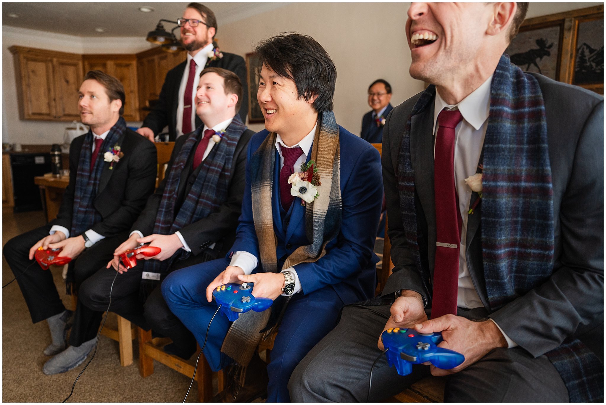 Groom hanging out and toasting and playing video games before the wedding | Snowbasin Resort Winter Wedding | Jessie and Dallin Photography