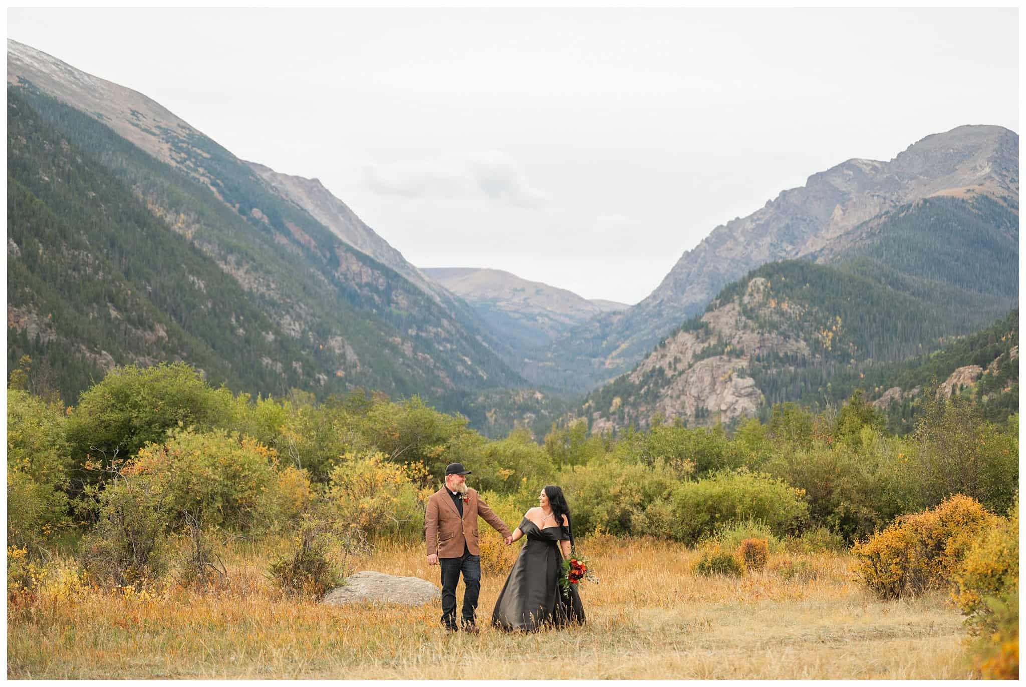 Bride in black dress and groom in brown leather jacket sharing moments at Rocky National Park | Fall Rocky Mountain National Park Elopement | Jessie and Dallin Photography