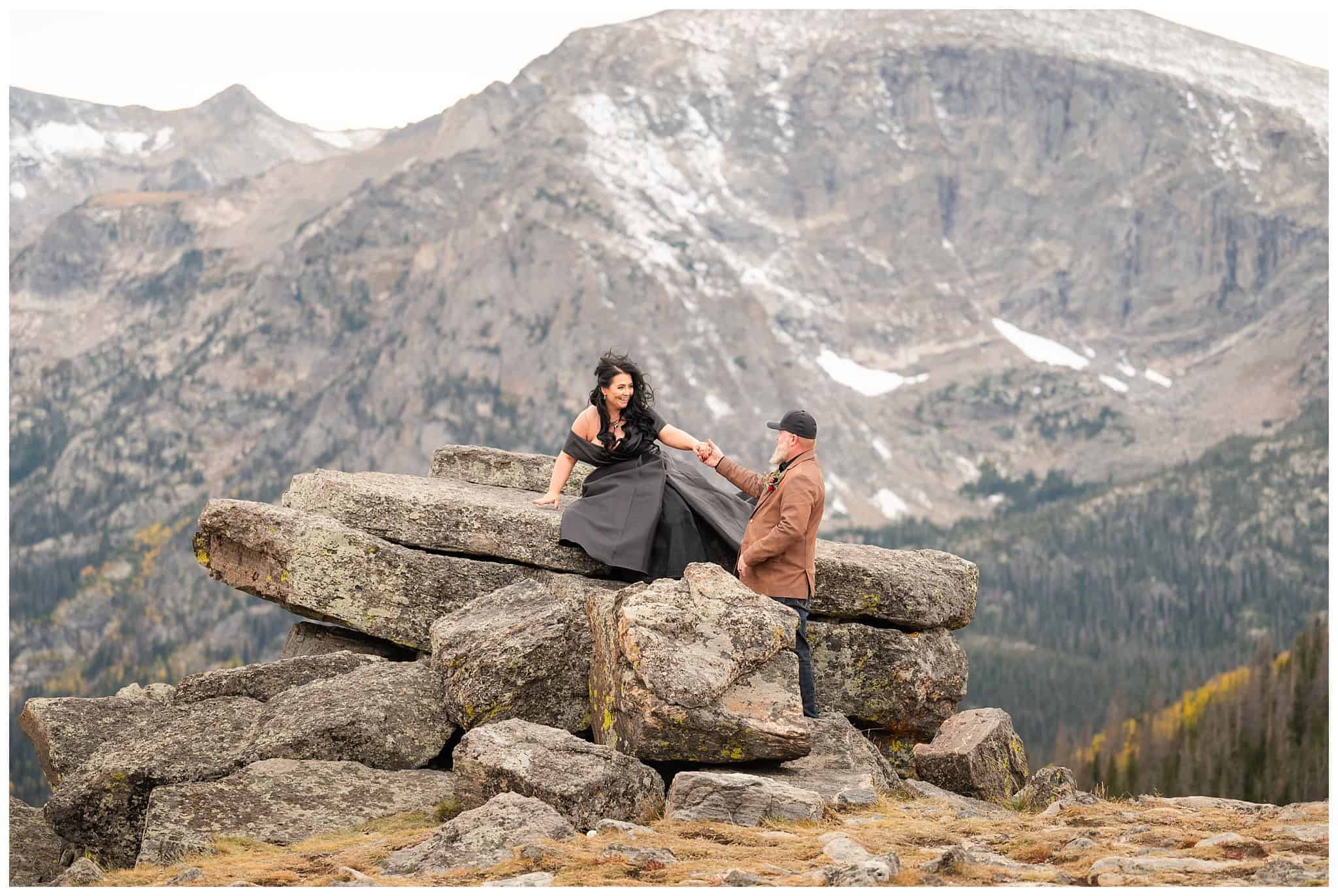 Bride in black dress and groom in brown leather jacket sharing moments in the windy tundra at Rocky National Park | Fall Rocky Mountain National Park Elopement | Jessie and Dallin Photography