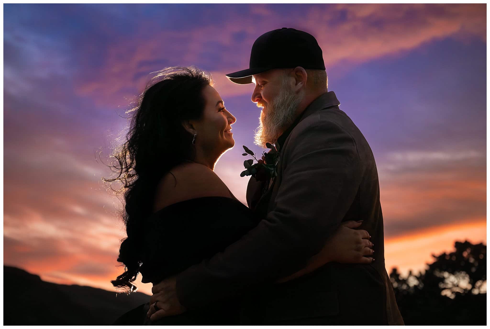 Bride in black dress and groom in brown leather jacket with an incredible sunset at Rocky National Park | Fall Rocky Mountain National Park Elopement | Jessie and Dallin Photography