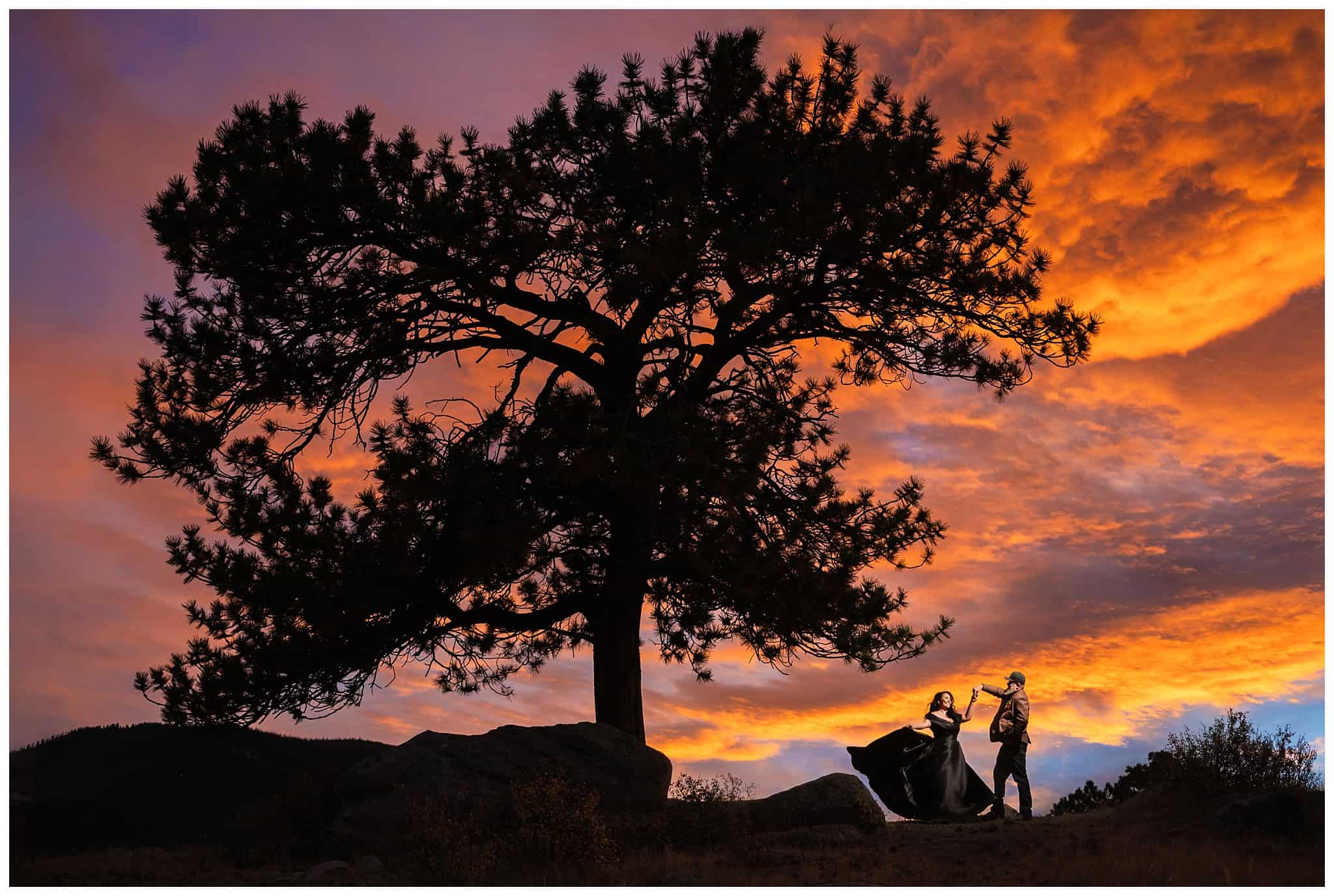 Bride in black dress and groom in brown leather jacket sharing moments with an incredible sunset at Rocky National Park | Fall Rocky Mountain National Park Elopement | Jessie and Dallin Photography