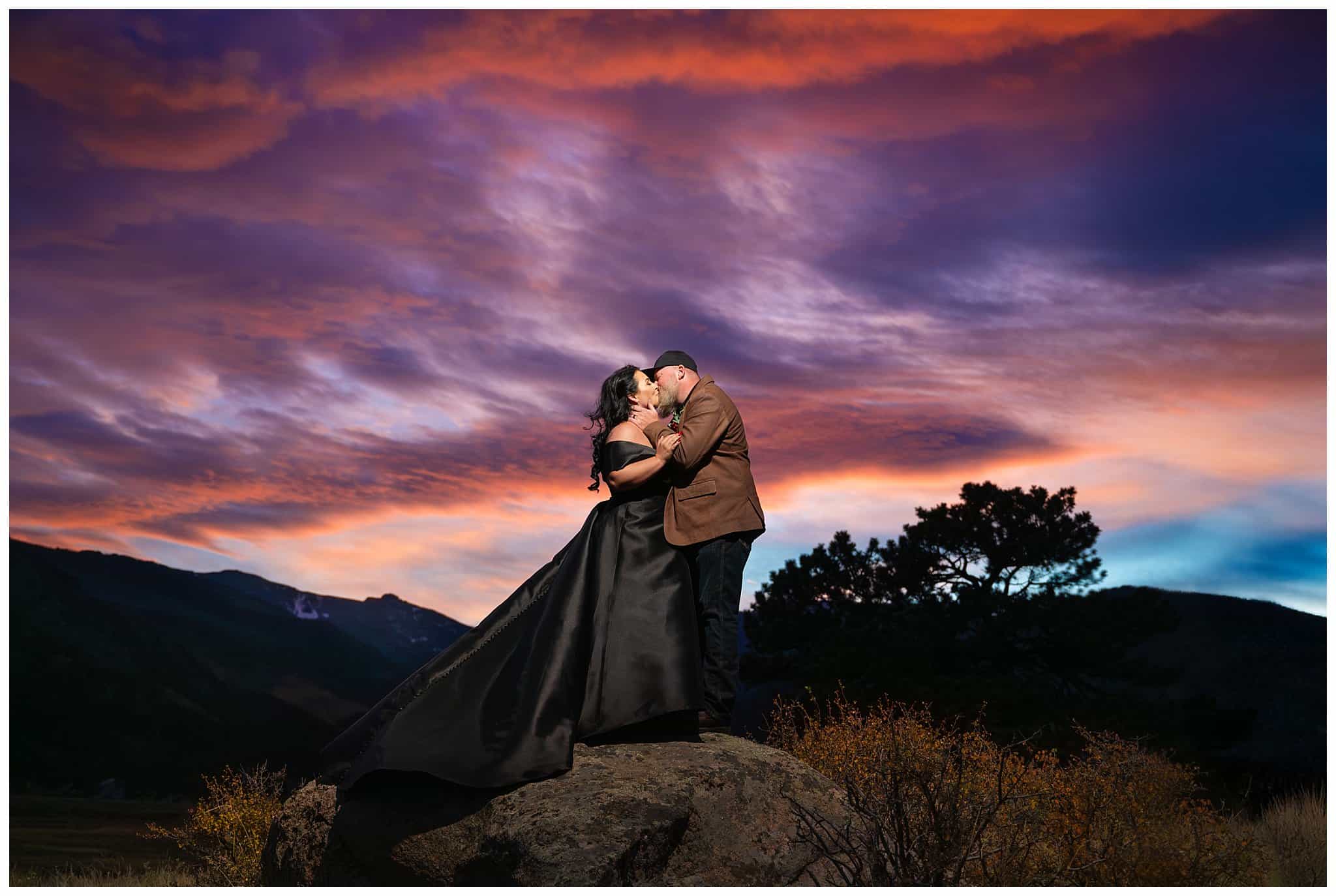 Bride in black dress and groom in brown leather jacket with an incredible sunset at Rocky National Park | Fall Rocky Mountain National Park Elopement | Jessie and Dallin Photography